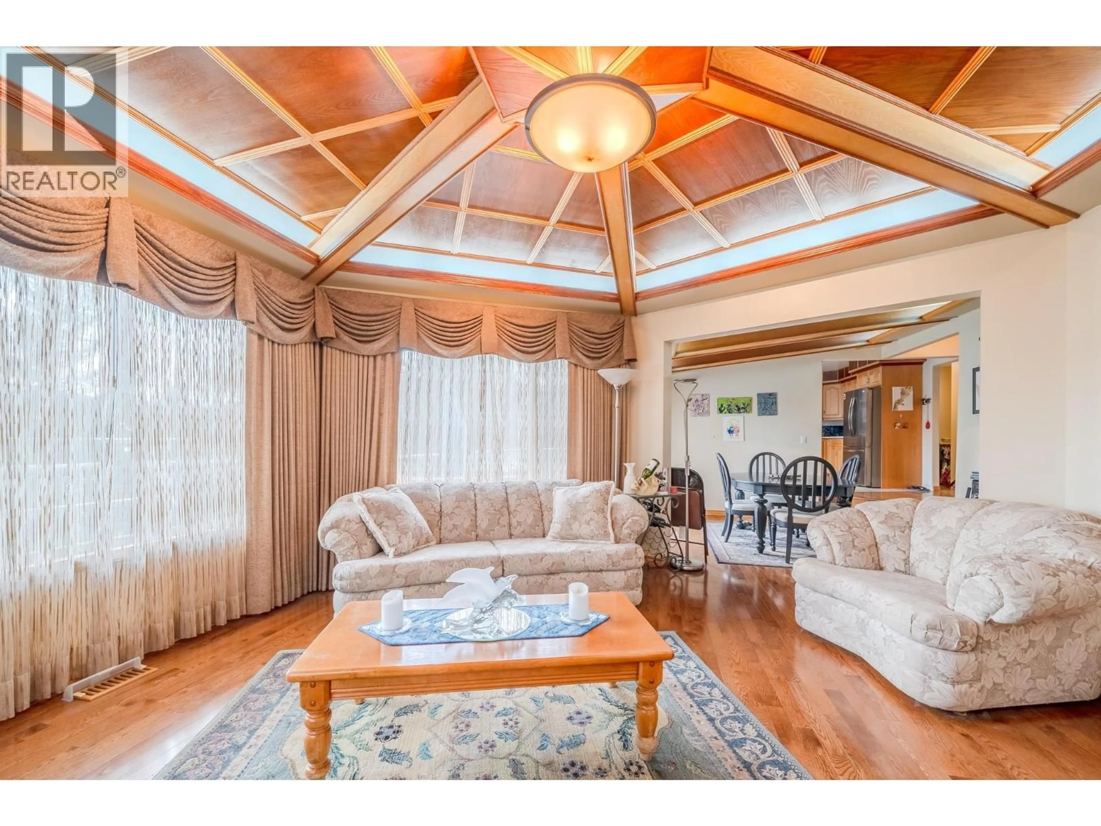 Living room with furniture, wood/laminate floor for 4882 GLOINNZUN CRESCENT, 108 Mile Ranch British Columbia V0K2Z0