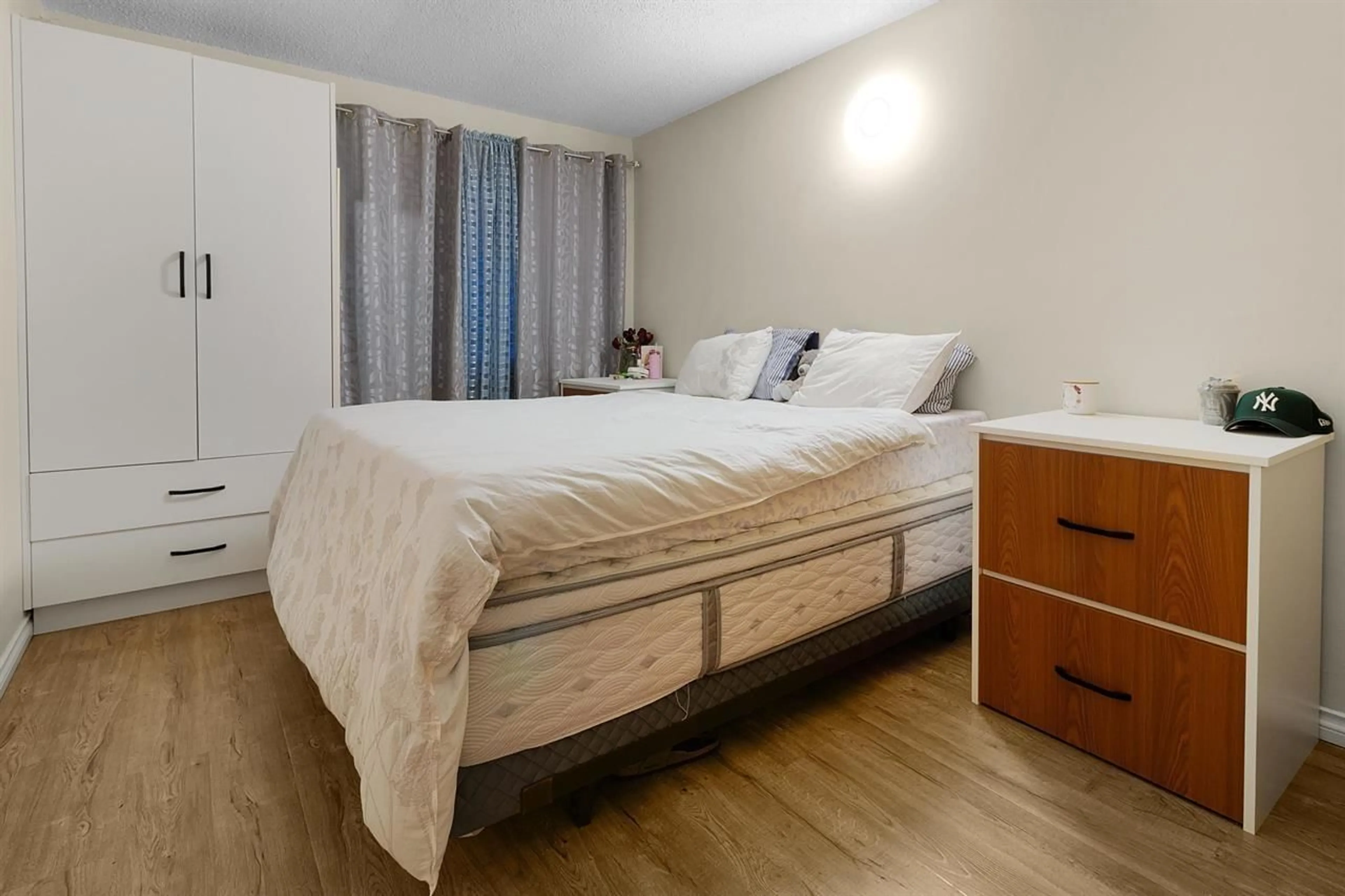 Bedroom with bed, wood/laminate floor for 202 - 7064 133B STREET, Surrey British Columbia V3W7Z2