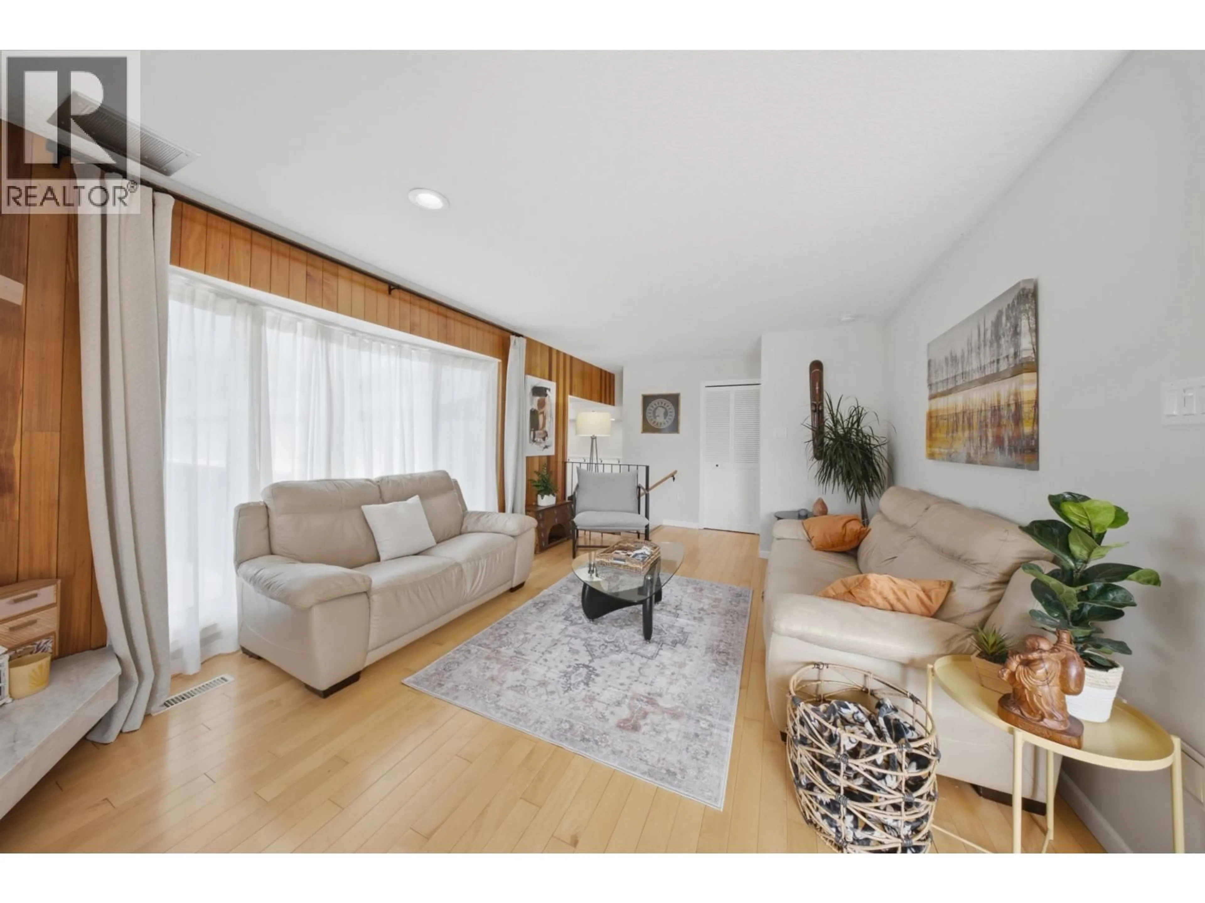 Living room with furniture, wood/laminate floor for 10604 106 AVENUE, Fort St. John British Columbia V1J6E1