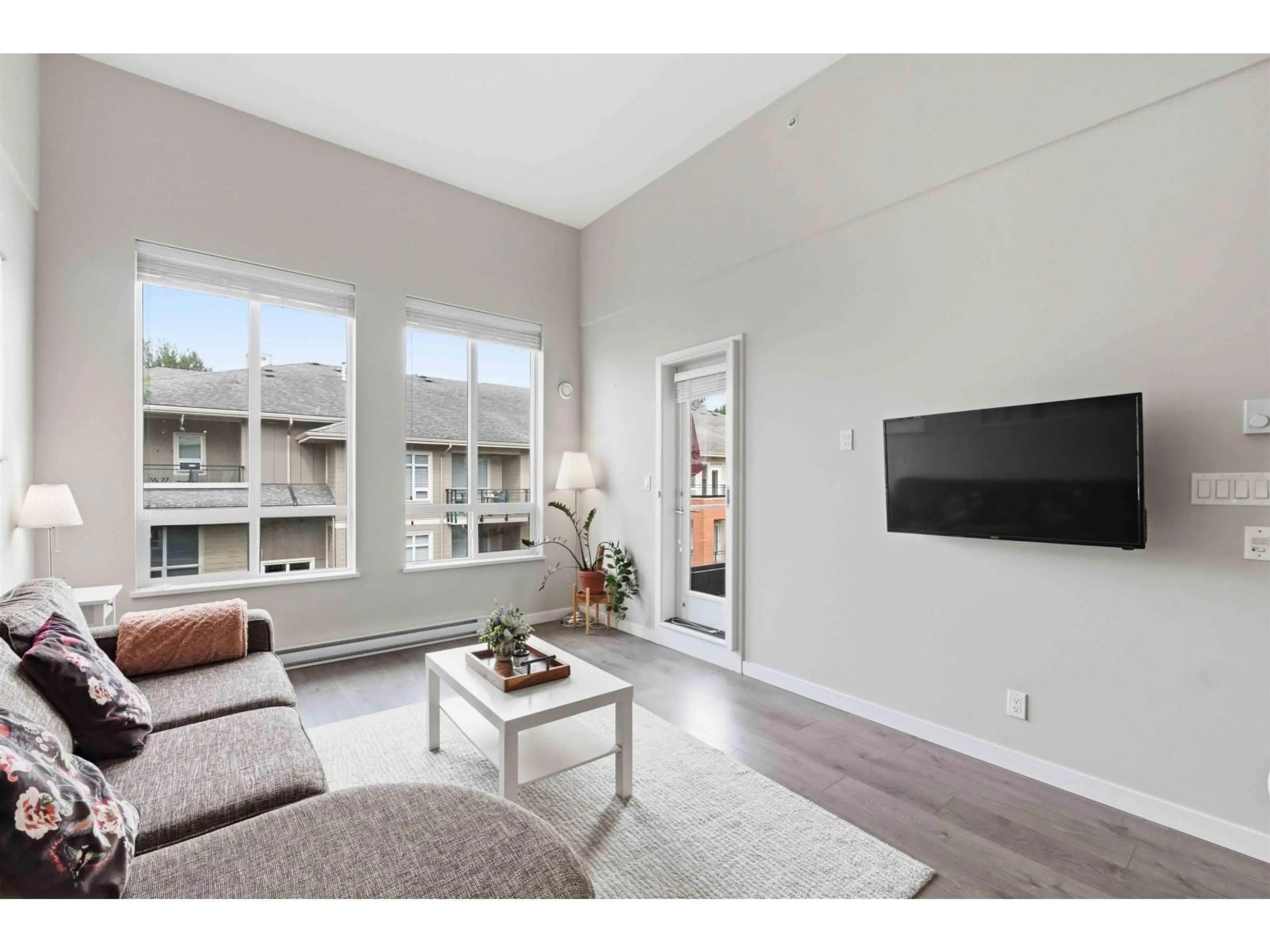 Living room with furniture, wood/laminate floor for E405 - 20211 66 AVENUE, Langley British Columbia V2Y0L4