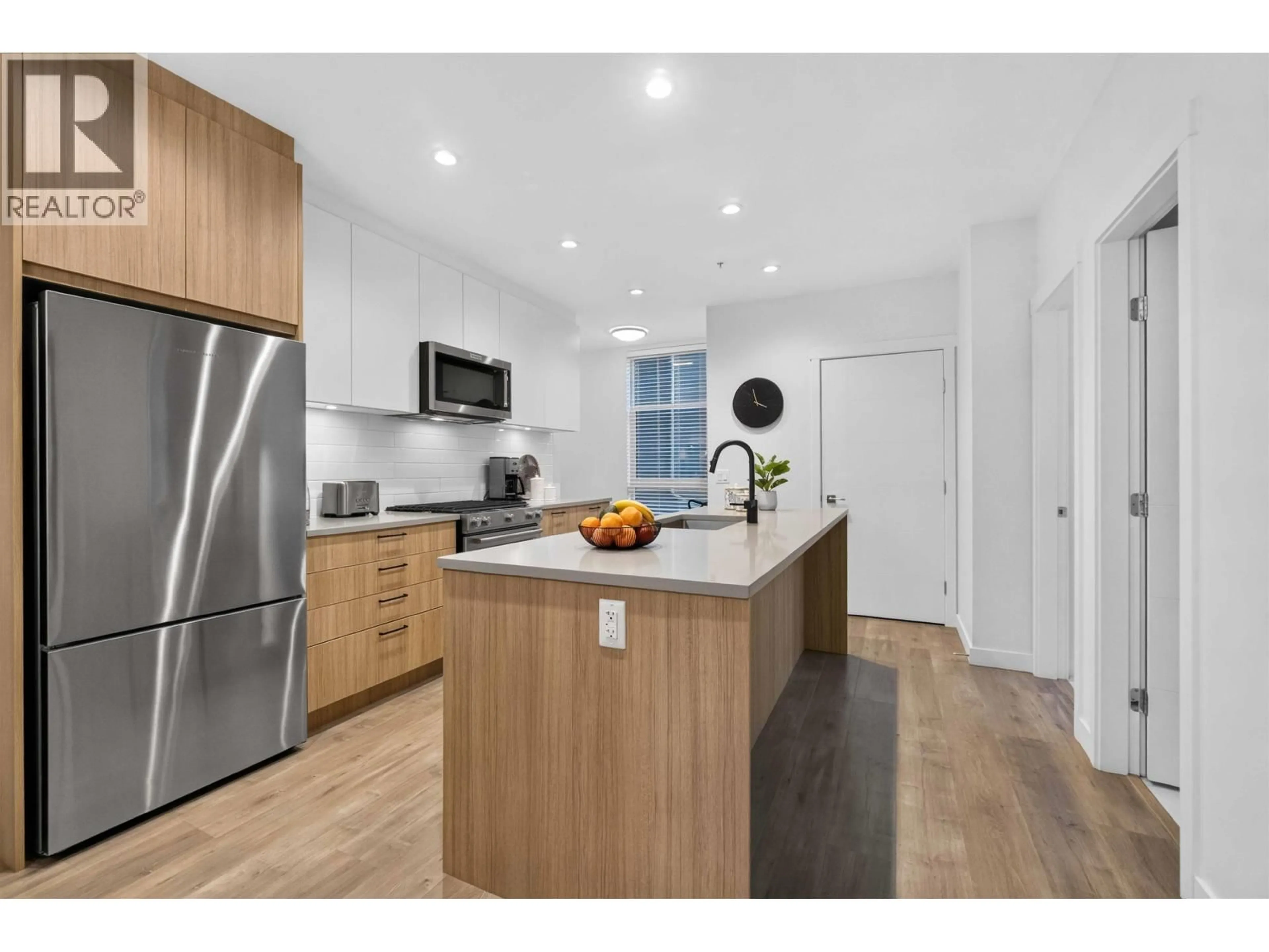 Open concept kitchen, wood/laminate floor for 103 - 707 COMO LAKE AVENUE, Coquitlam British Columbia V3J0J5