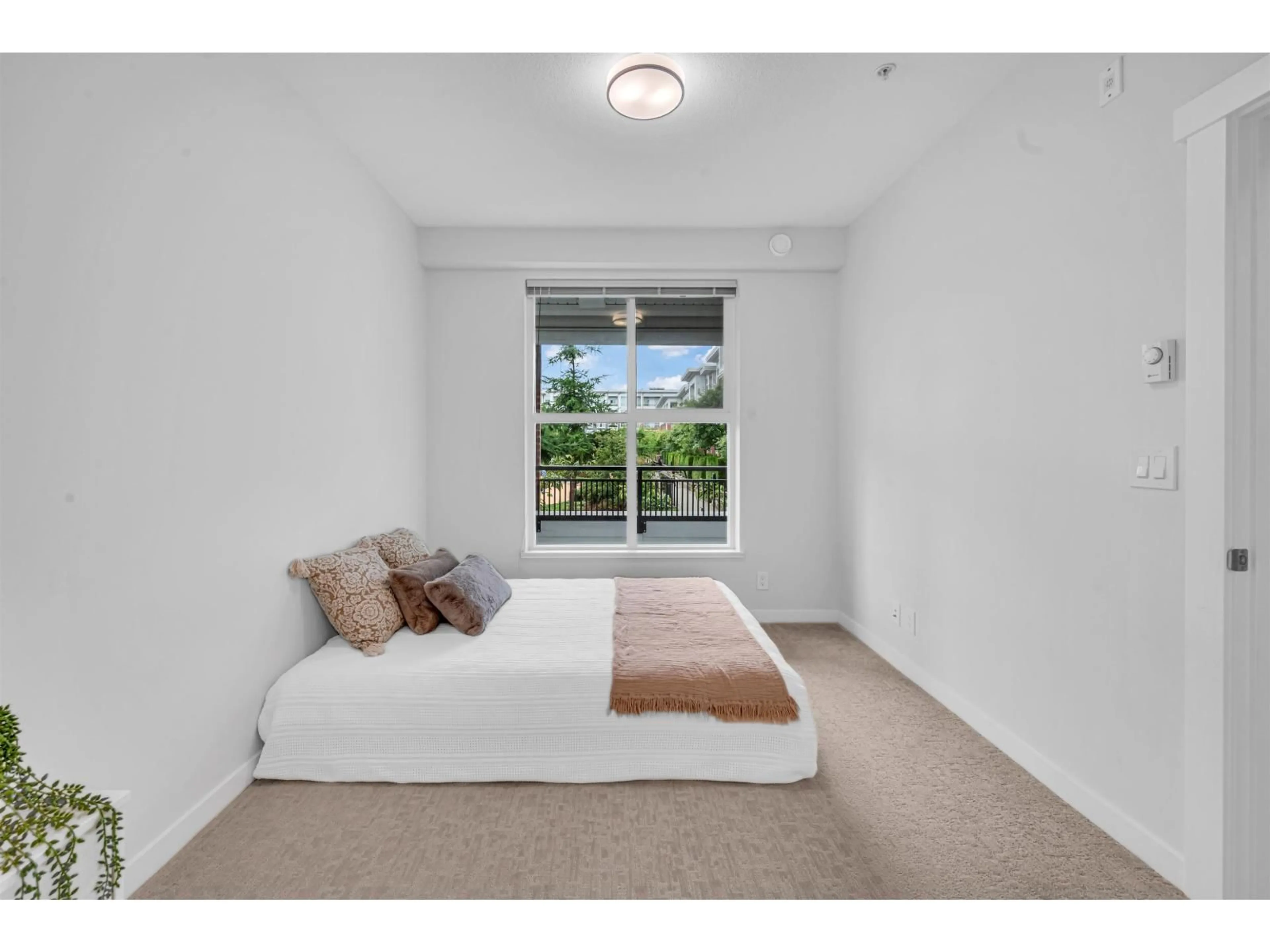 Bedroom with bed, carpet floor for A205 - 8150 207 STREET, Langley British Columbia V2Y4J2