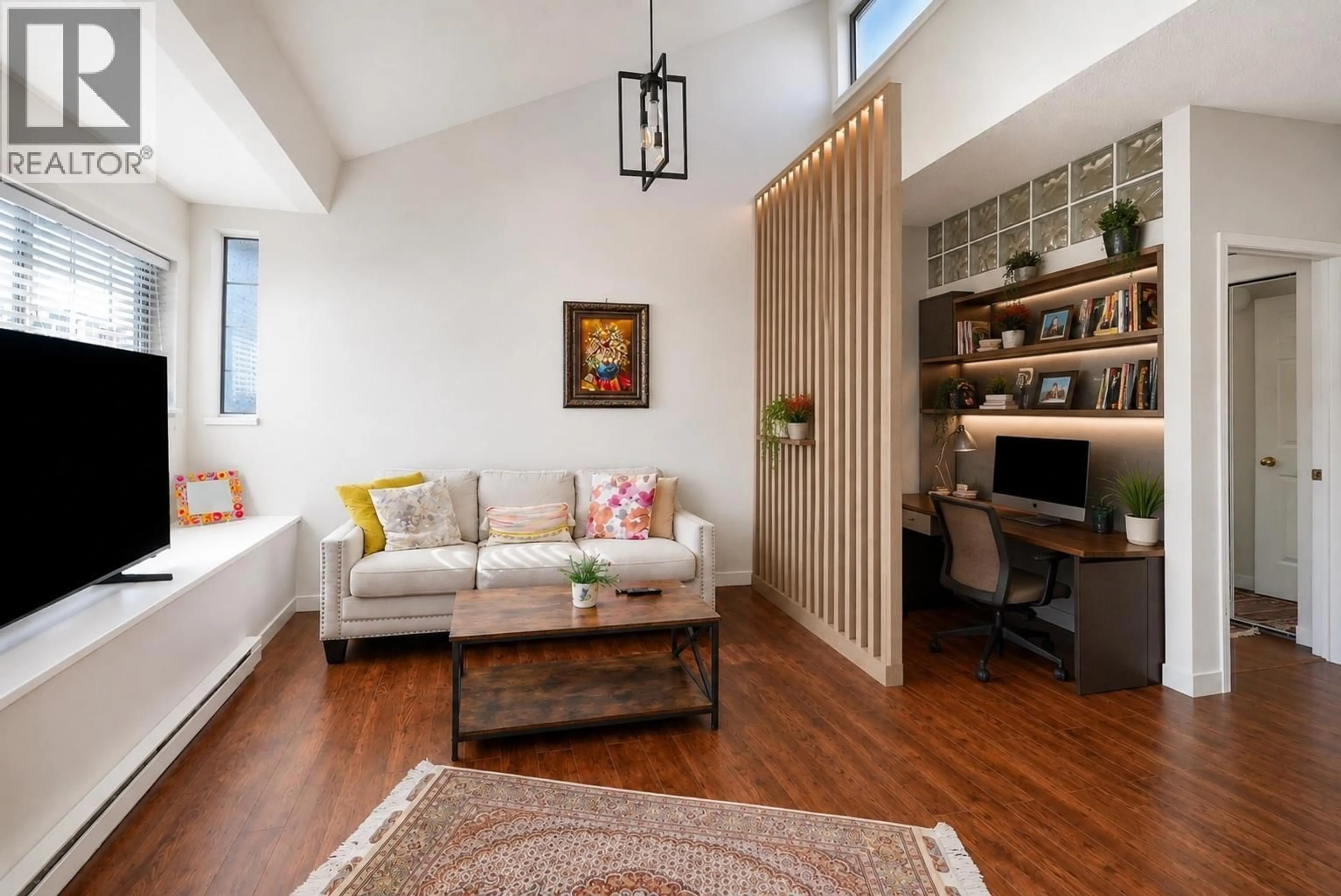 Living room with furniture, wood/laminate floor for 309 - 125 18TH STREET, North Vancouver British Columbia V7M1W5