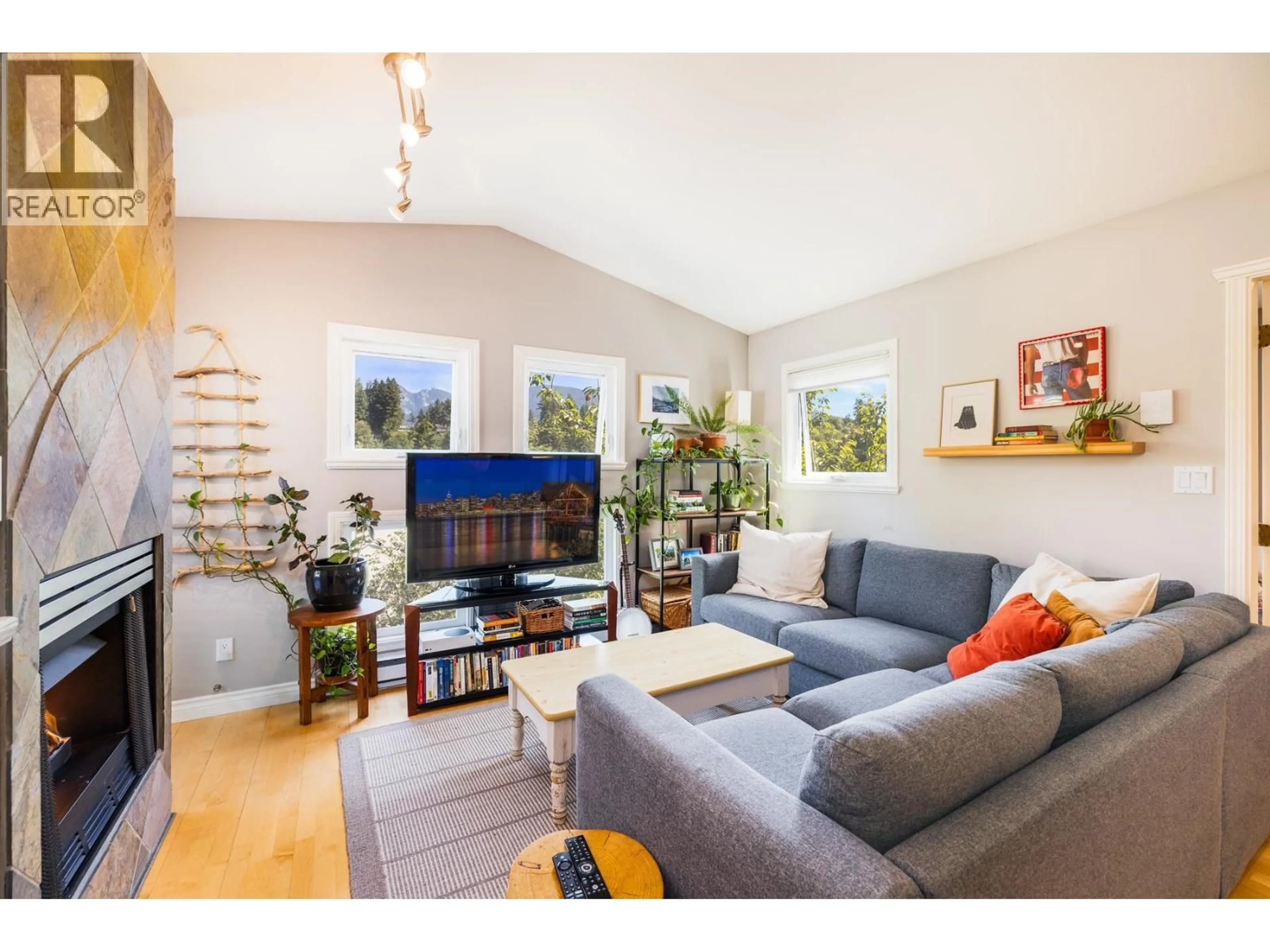 Living room with furniture, wood/laminate floor for 303 - 1528 BOWSER AVENUE, North Vancouver British Columbia V7P2Y3