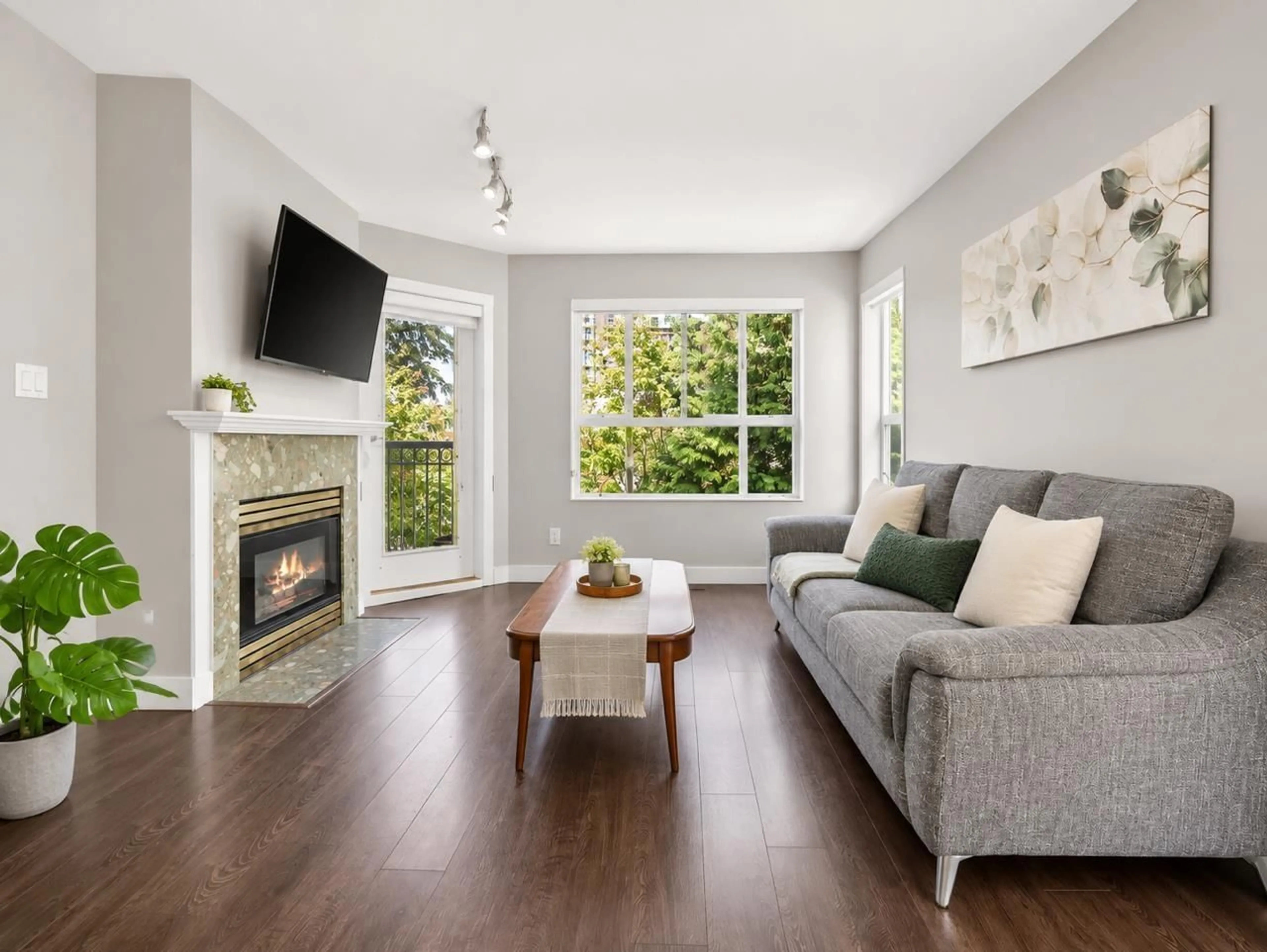 Living room with furniture, wood/laminate floor for 309 - 13939 LAUREL DRIVE, Surrey British Columbia V3T1A8