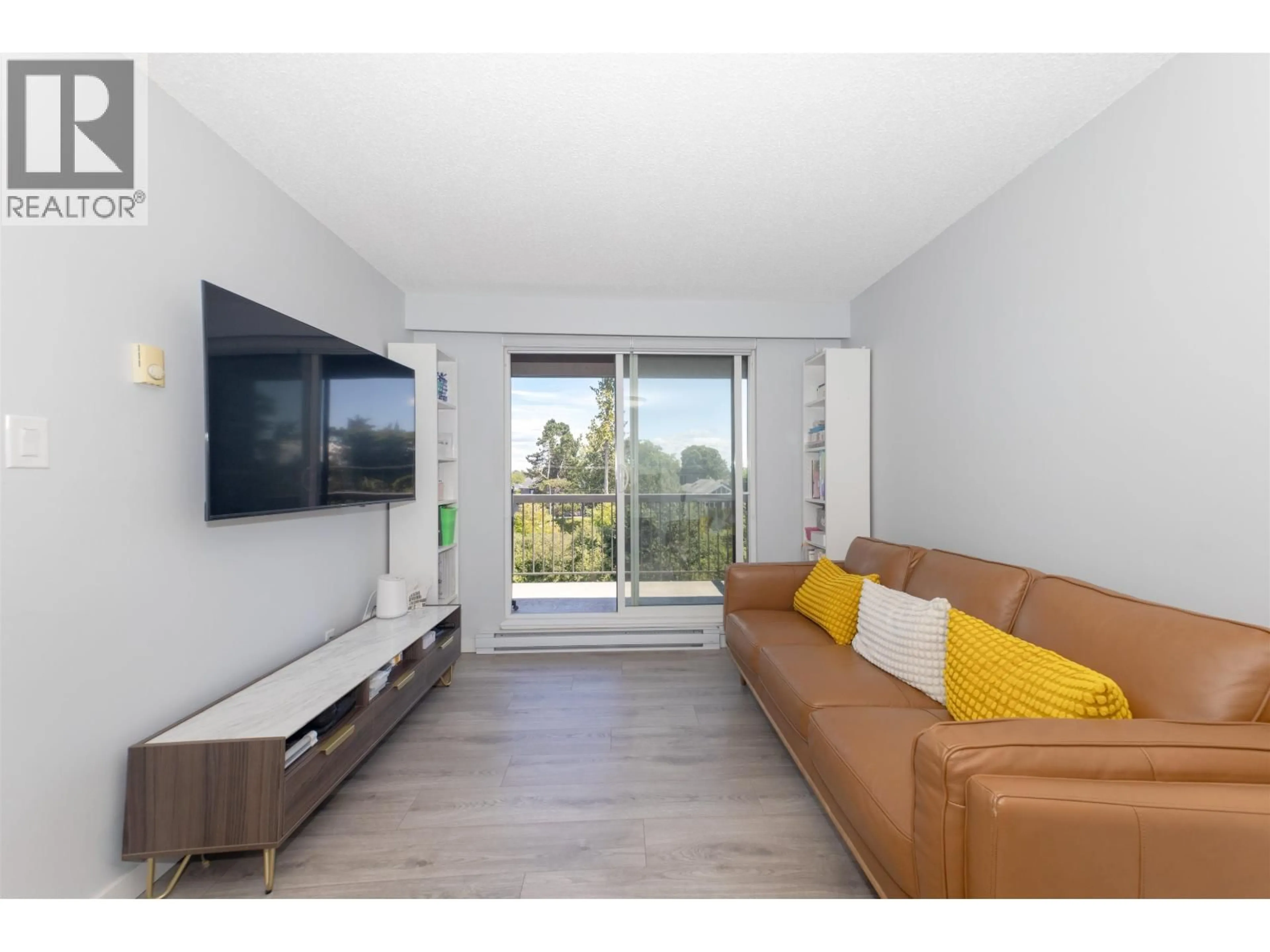 Living room with furniture, wood/laminate floor for 401 - 8120 COLONIAL DRIVE, Richmond British Columbia V7C4V2