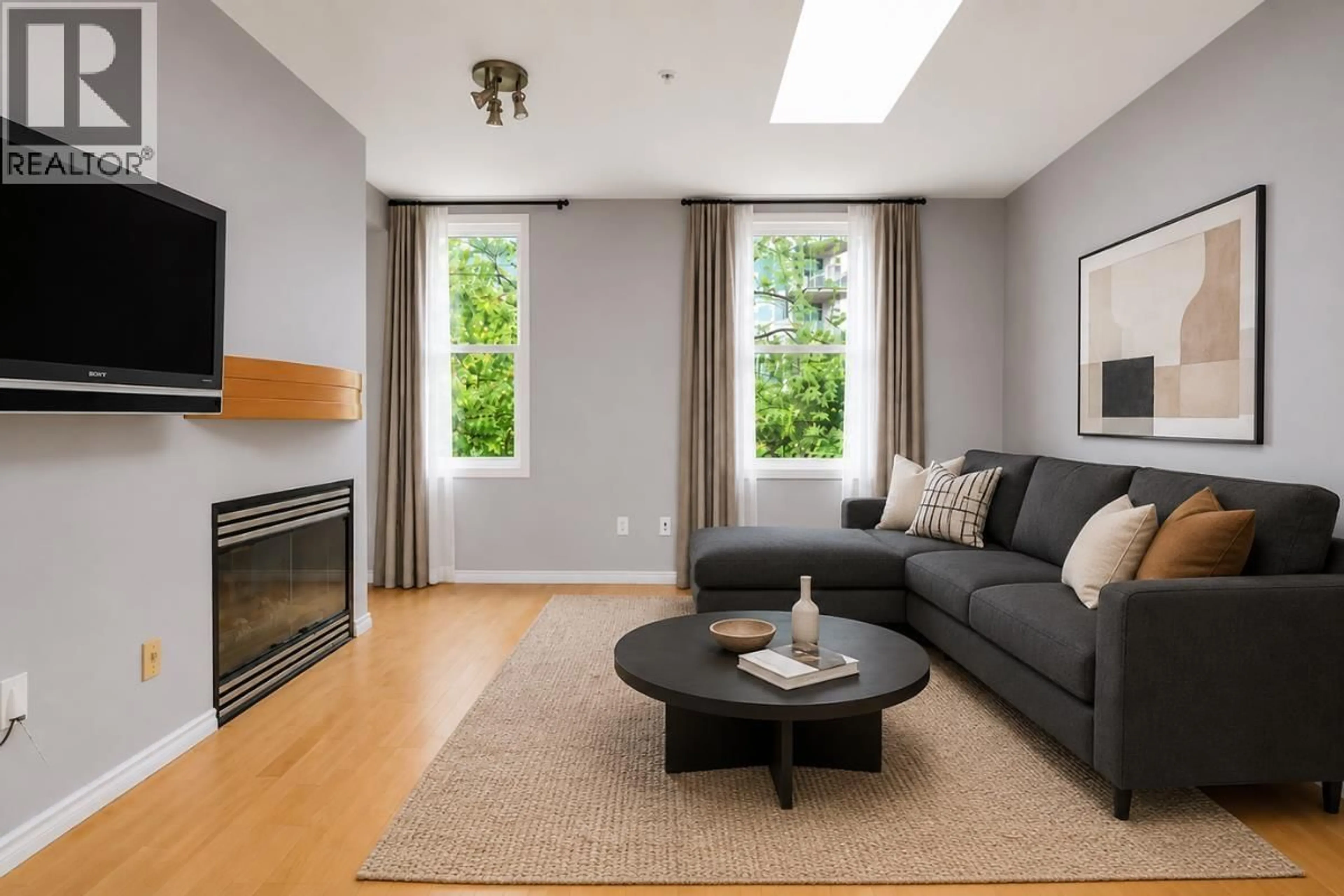 Living room with furniture, wood/laminate floor for 103 - 108 ESPLANADE, North Vancouver British Columbia V7M3M8