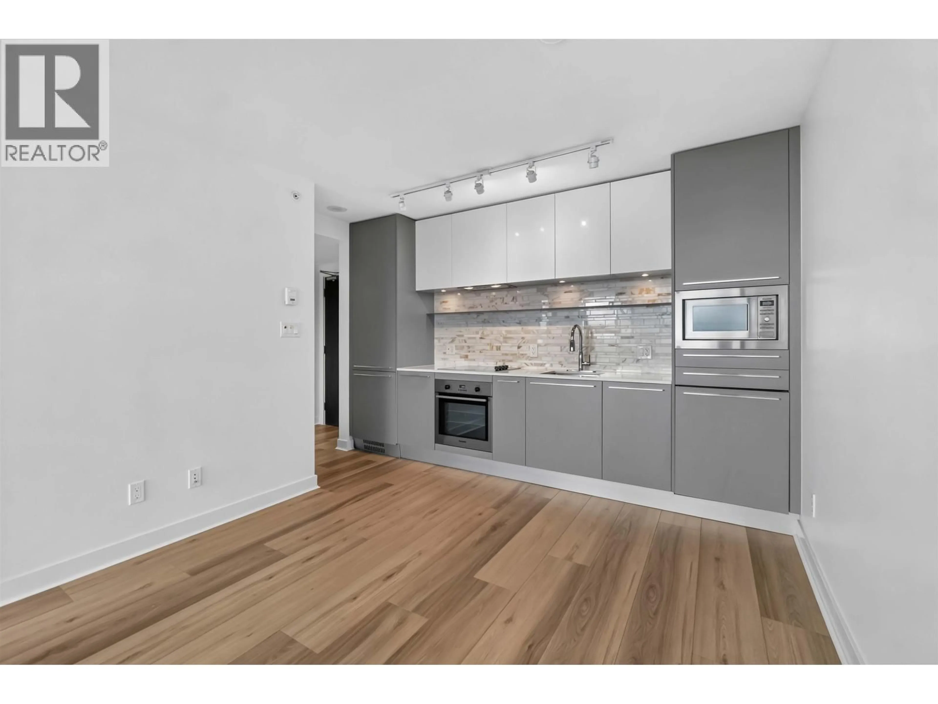 Open concept kitchen, wood/laminate floor for 2206 - 8131 NUNAVUT LANE, Vancouver British Columbia V5X0E2