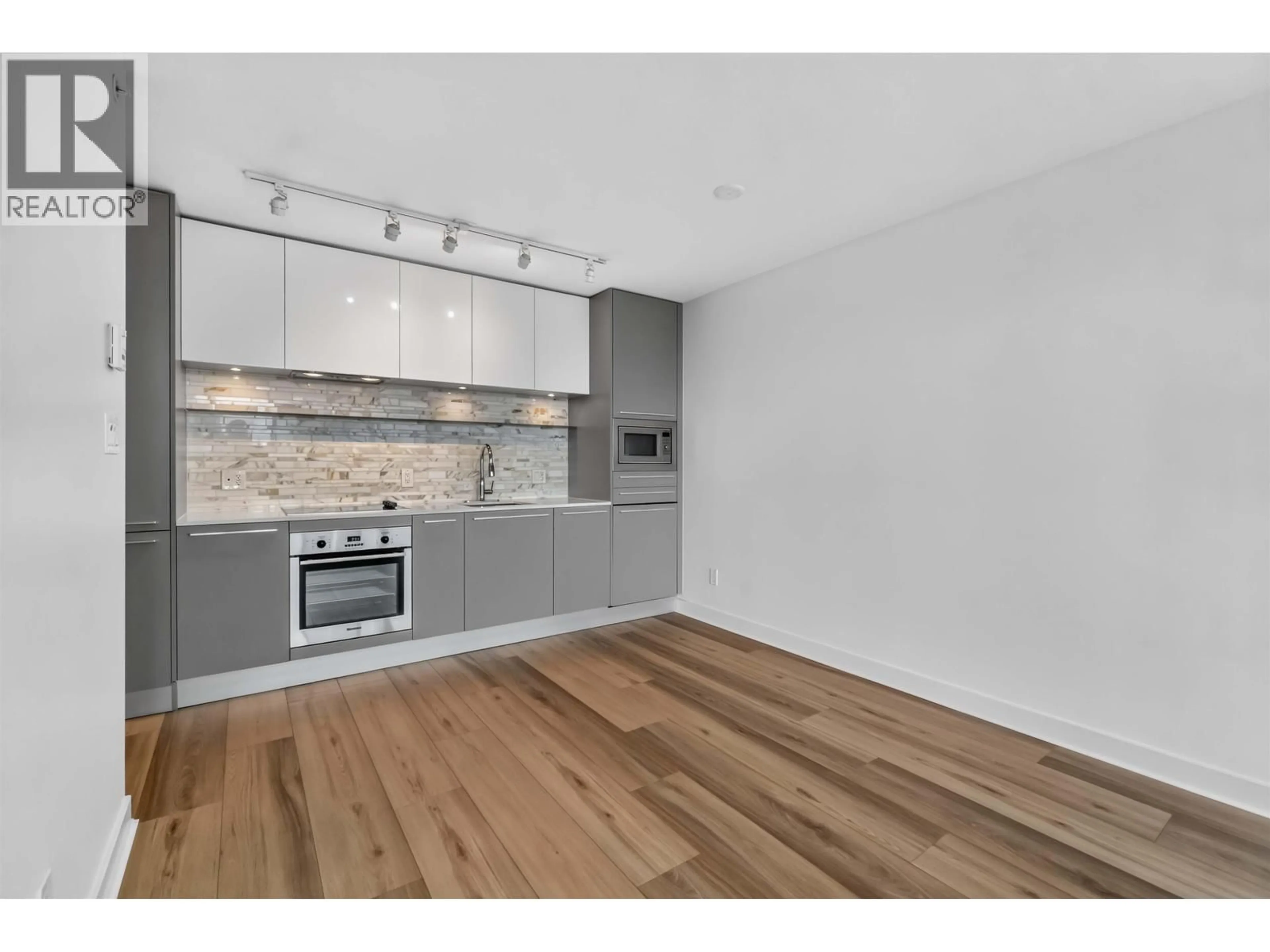 Open concept kitchen, wood/laminate floor for 2206 - 8131 NUNAVUT LANE, Vancouver British Columbia V5X0E2