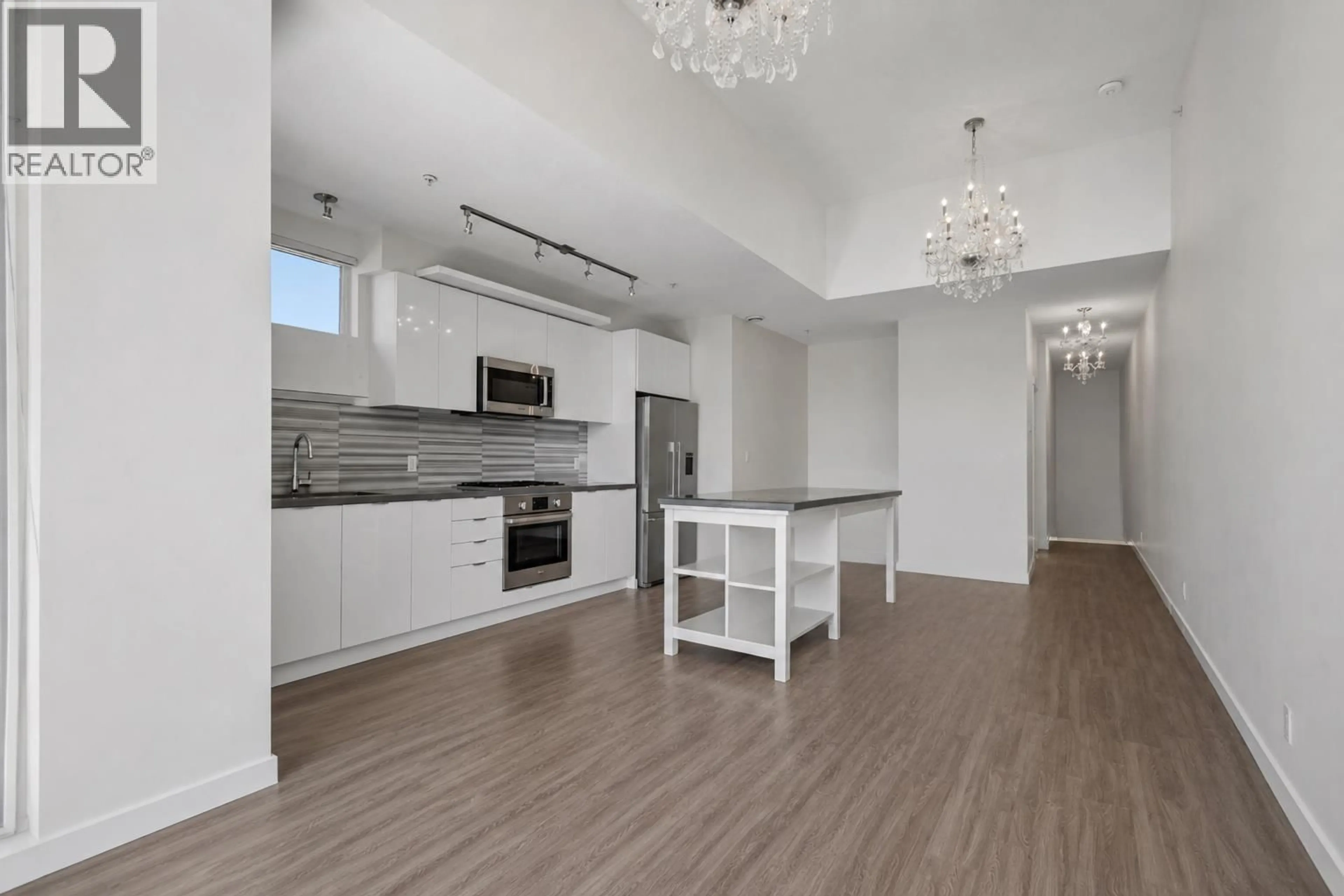 Open concept kitchen, wood/laminate floor for 312 - 3138 RIVERWALK AVENUE, Vancouver British Columbia V5S0B6