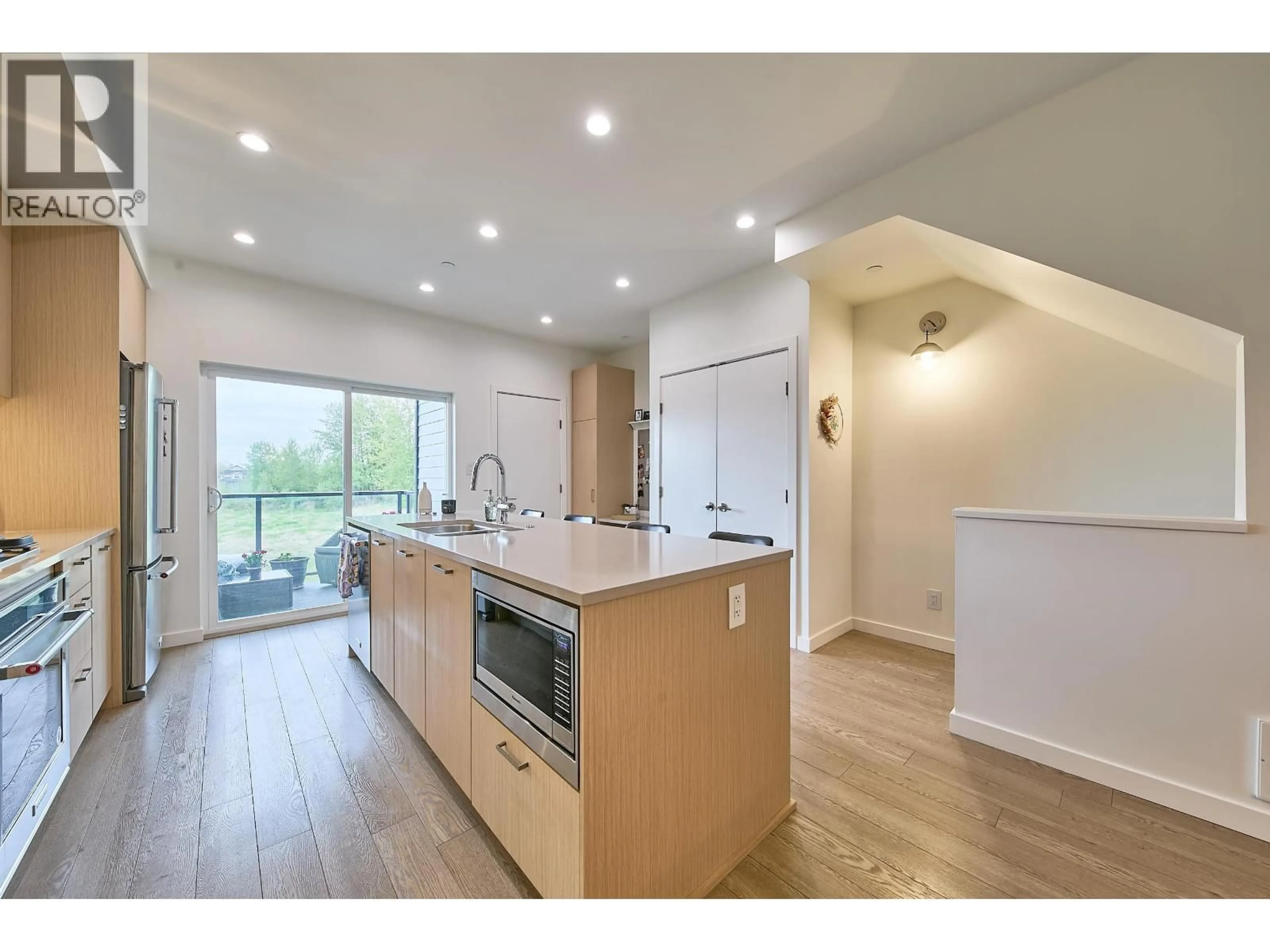 Open concept kitchen, wood/laminate floor for 204 - 19451 SUTTON AVENUE, Pitt Meadows British Columbia V3Y0G6