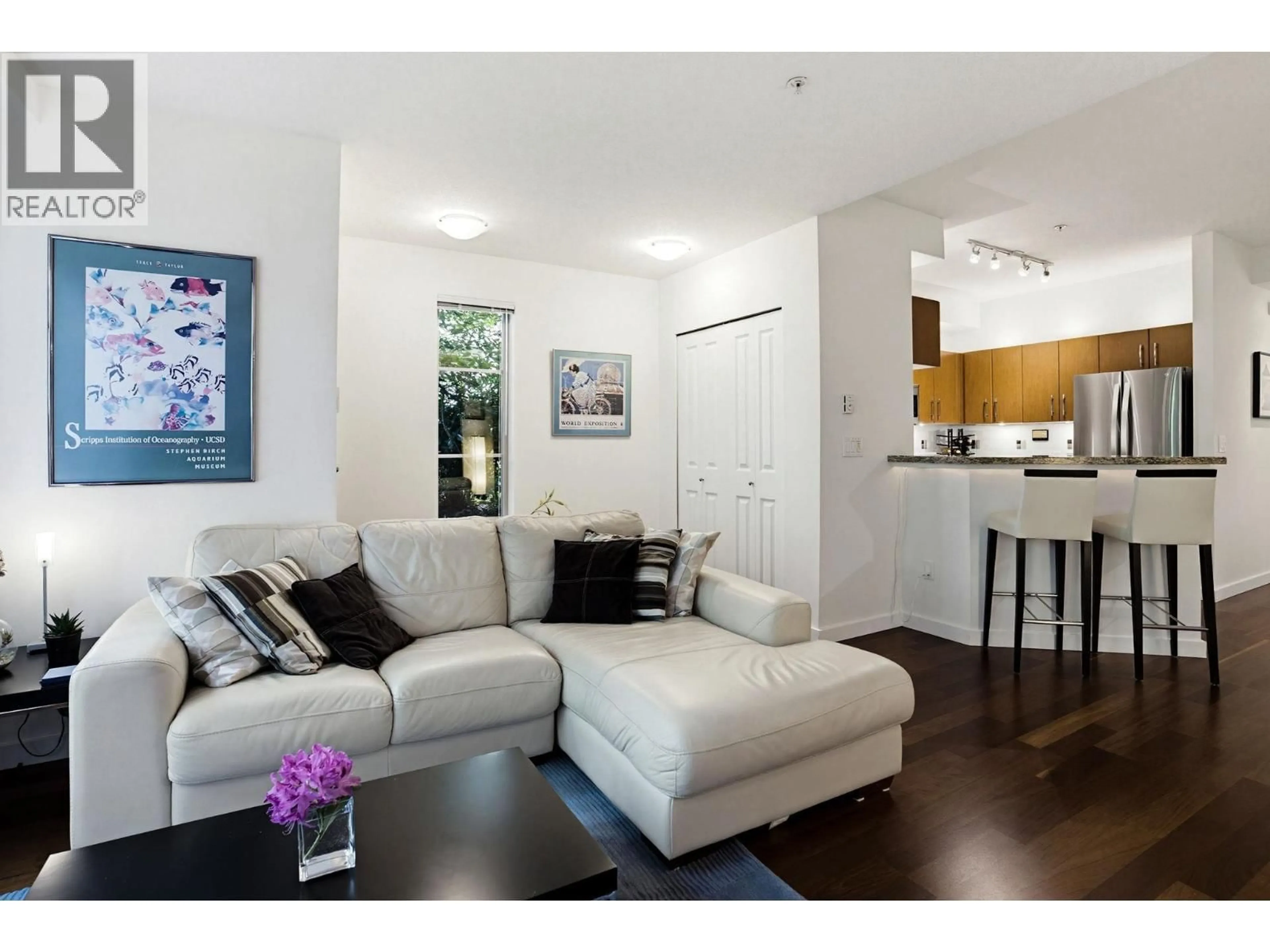 Living room with furniture, wood/laminate floor for 6230 LOGAN LANE, Vancouver British Columbia V6T2K9