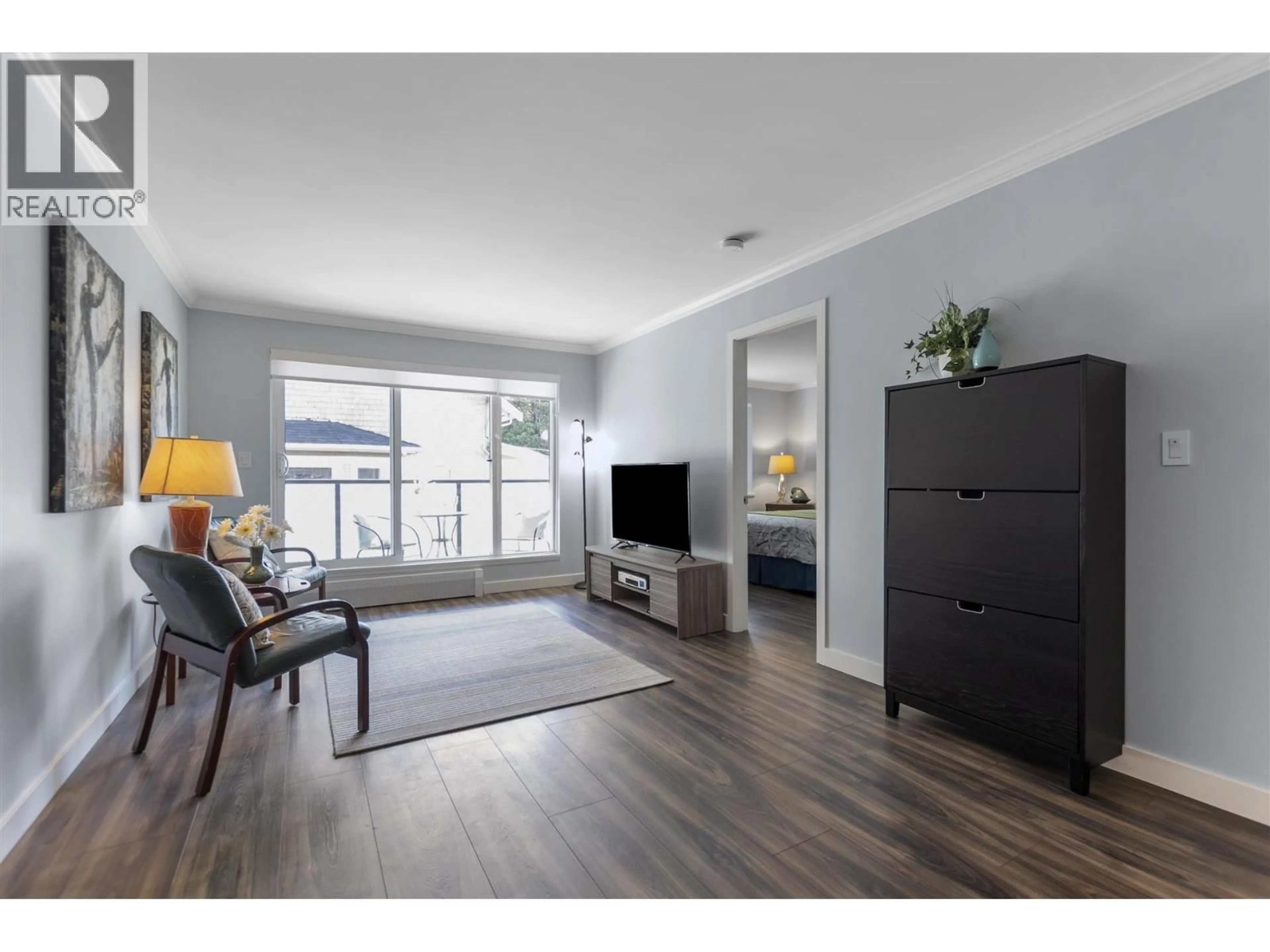 Living room with furniture, wood/laminate floor for 302 - 2328 OXFORD STREET, Vancouver British Columbia V5L1G3