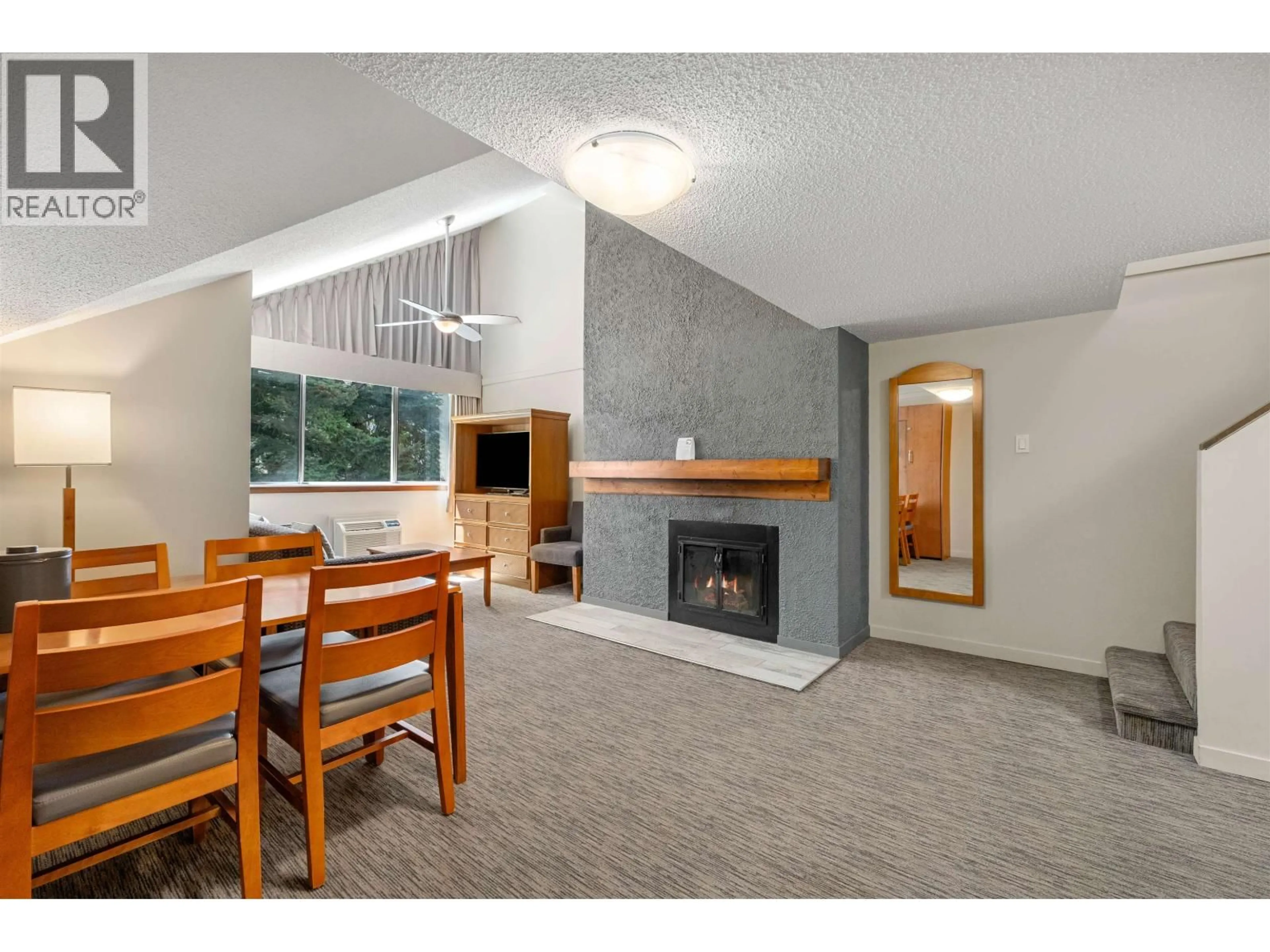 Living room with furniture, wood/laminate floor for 360 - 4429 SUNDIAL PLACE, Whistler British Columbia V8E1G8