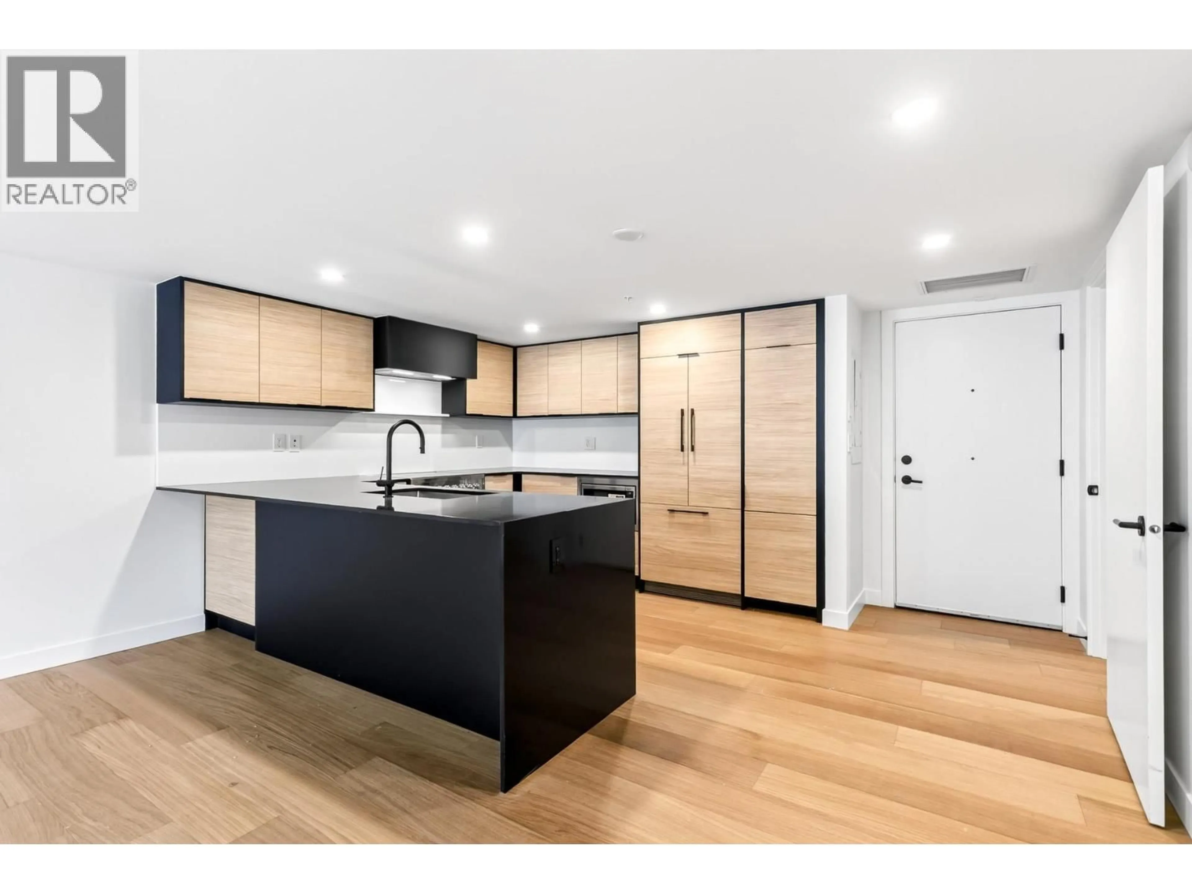Open concept kitchen, wood/laminate floor for 103 - 6485 MANITOBA STREET, Vancouver British Columbia V5Y0P7