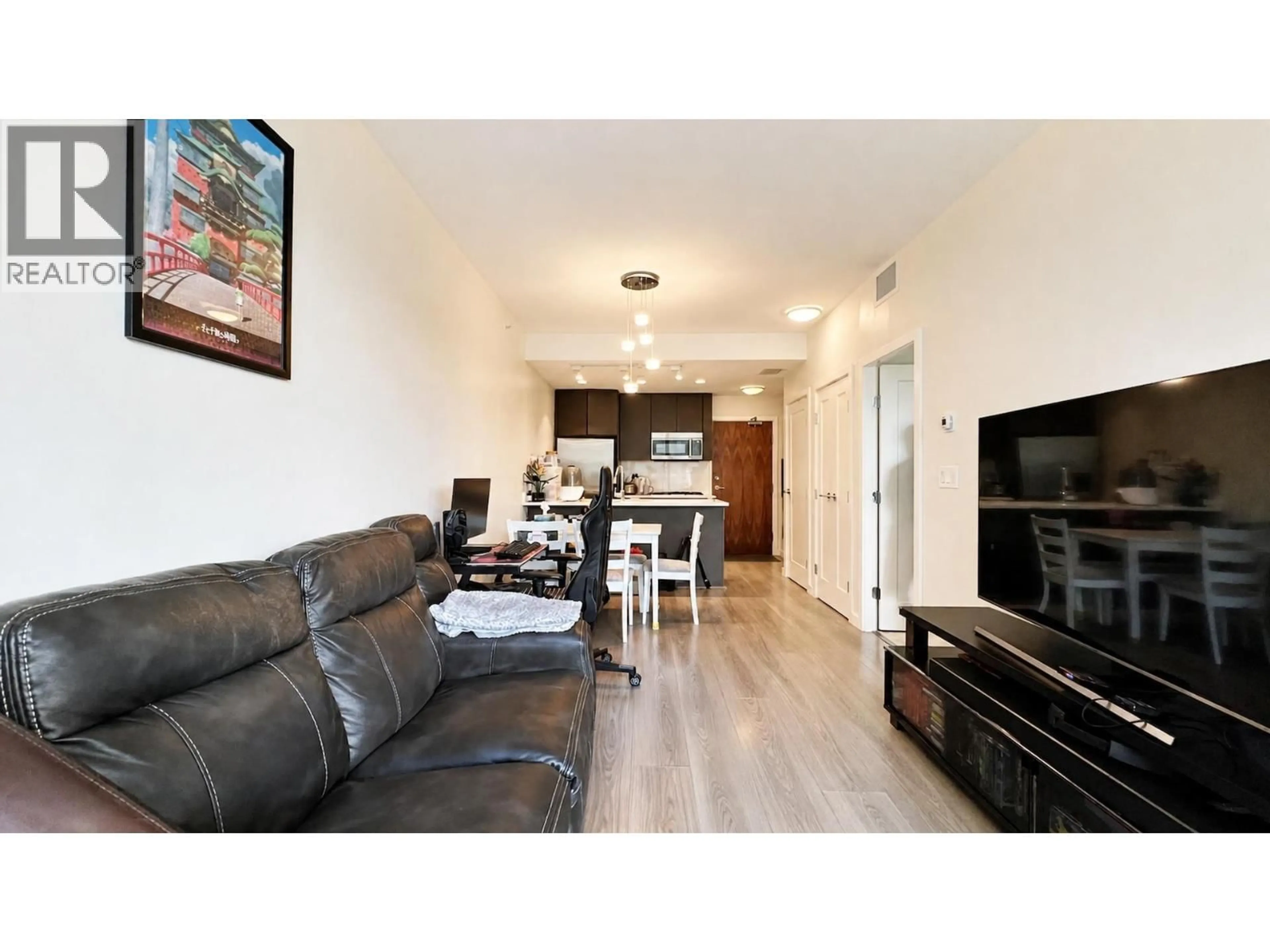 Living room with furniture, wood/laminate floor for 703 - 3333 SEXSMITH ROAD, Richmond British Columbia V6X0R7