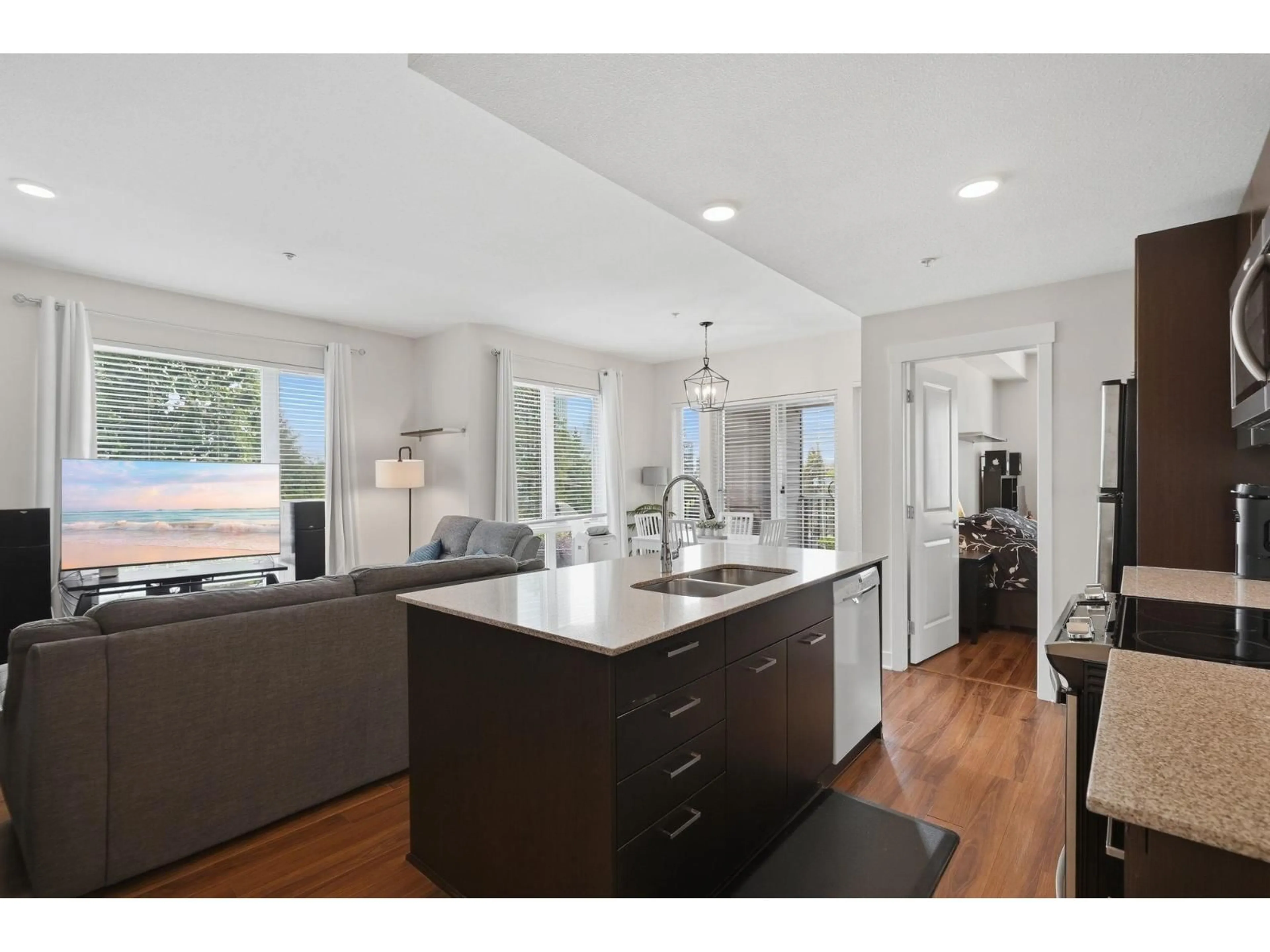 Open concept kitchen, wood/laminate floor for 304 - 13339 102A AVENUE, Surrey British Columbia V3T0C5