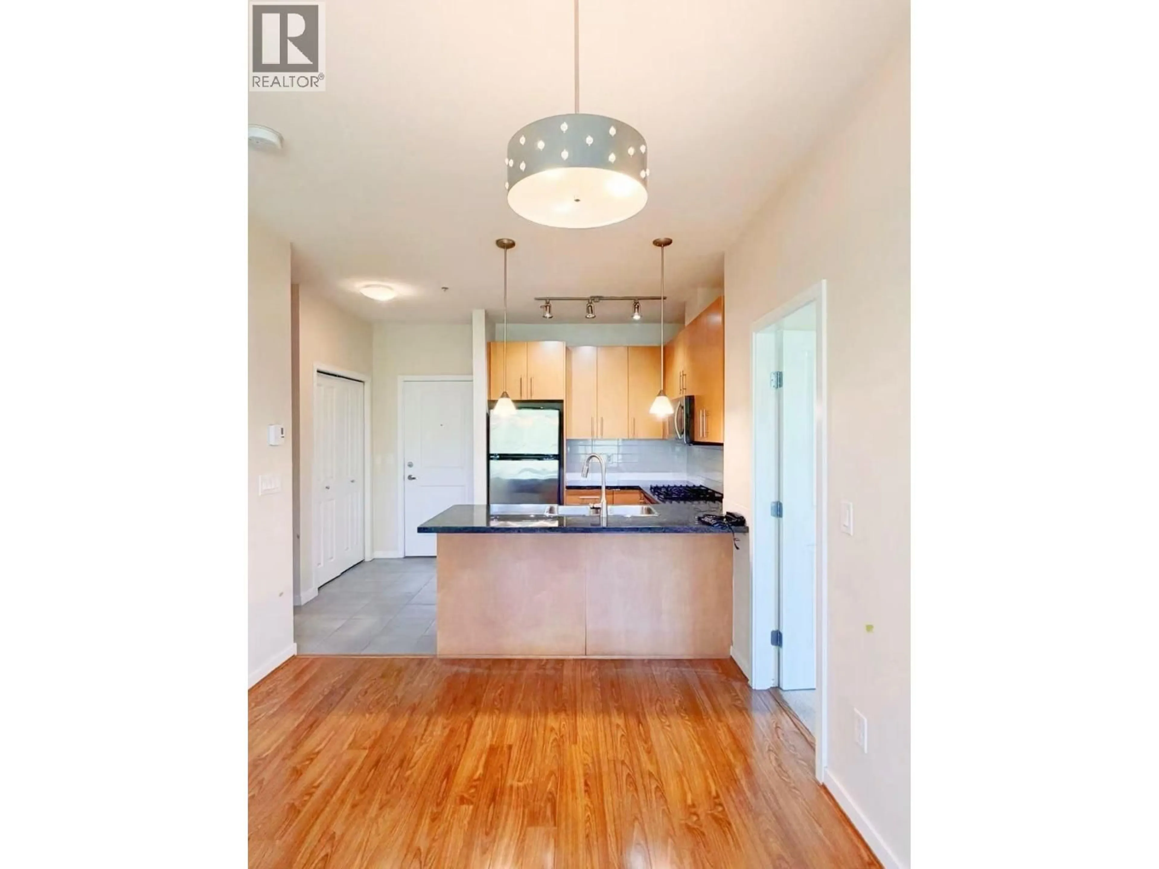 Open concept kitchen, wood/laminate floor for 408 - 3551 FOSTER AVENUE, Vancouver British Columbia V5R0A1