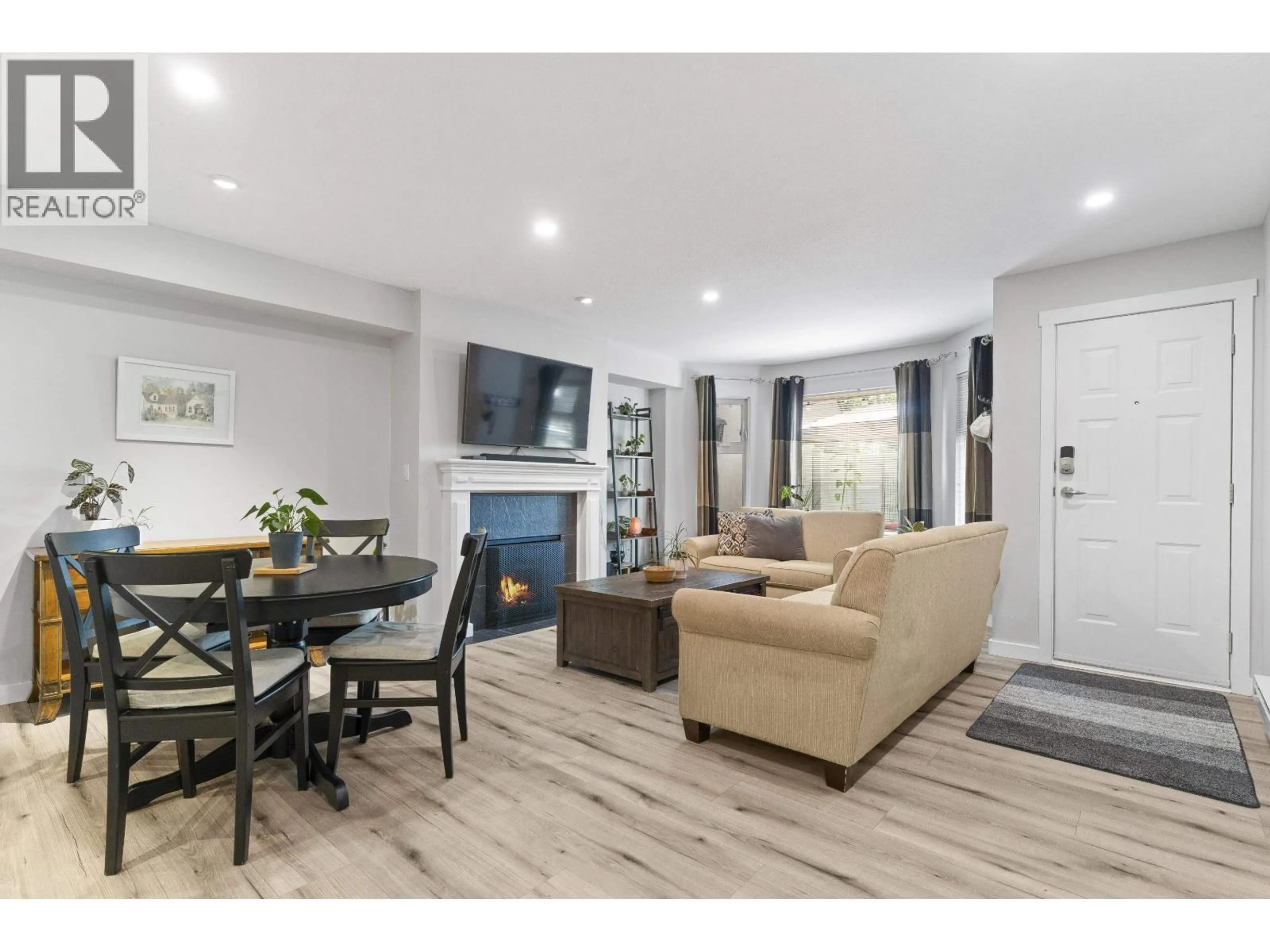 Living room with furniture, wood/laminate floor for A102 - 4811 53 STREET, Delta British Columbia V4K2Z3