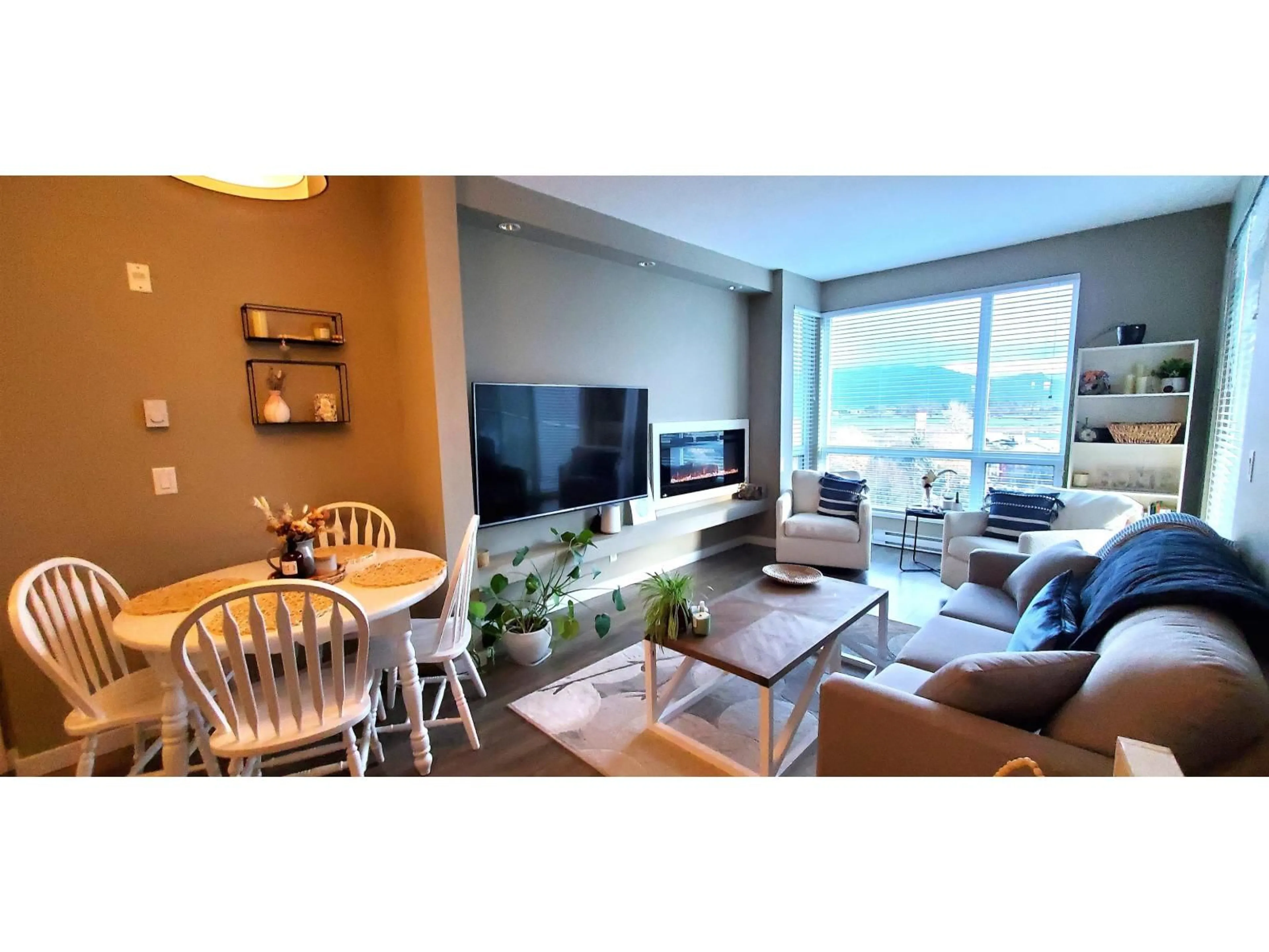 Living room with furniture, wood/laminate floor for 409 - 2242 WHATCOM ROAD, Abbotsford British Columbia V3G0G3
