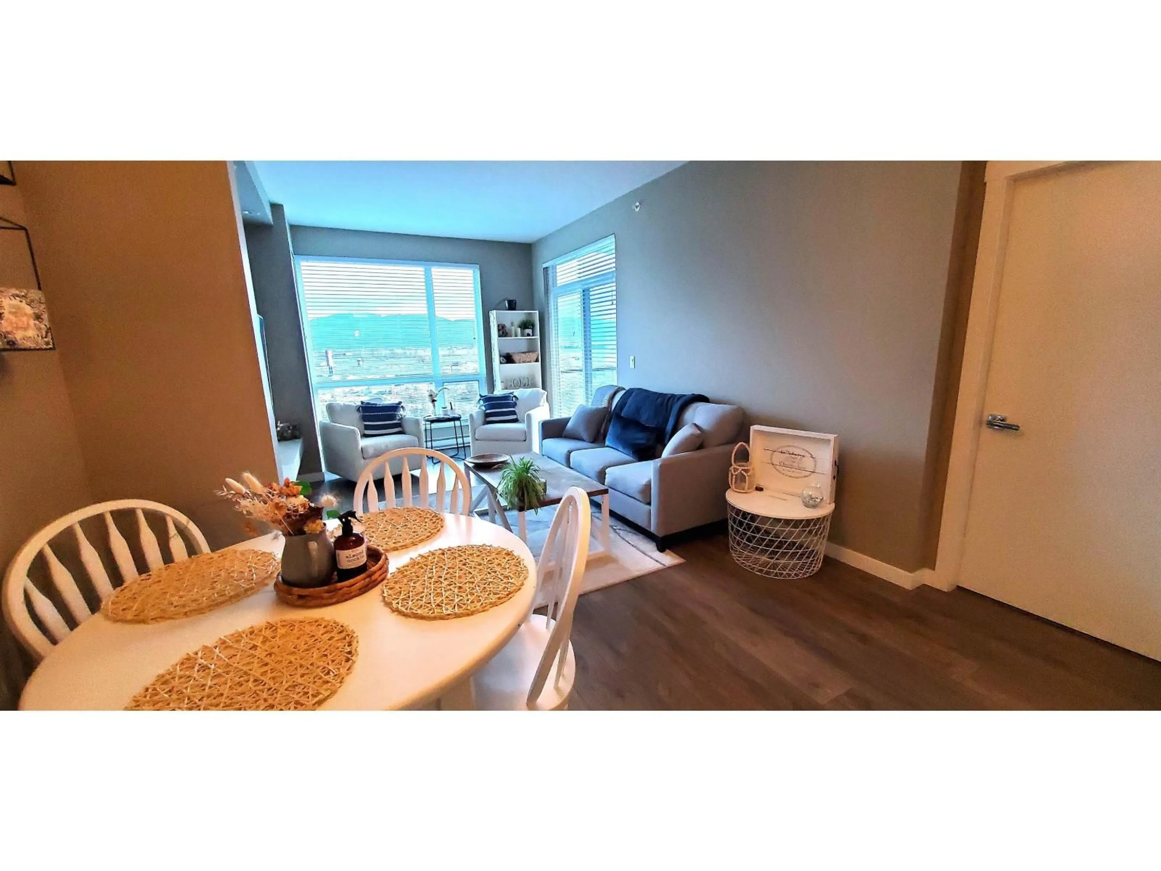 Living room with furniture, wood/laminate floor for 409 - 2242 WHATCOM ROAD, Abbotsford British Columbia V3G0G3