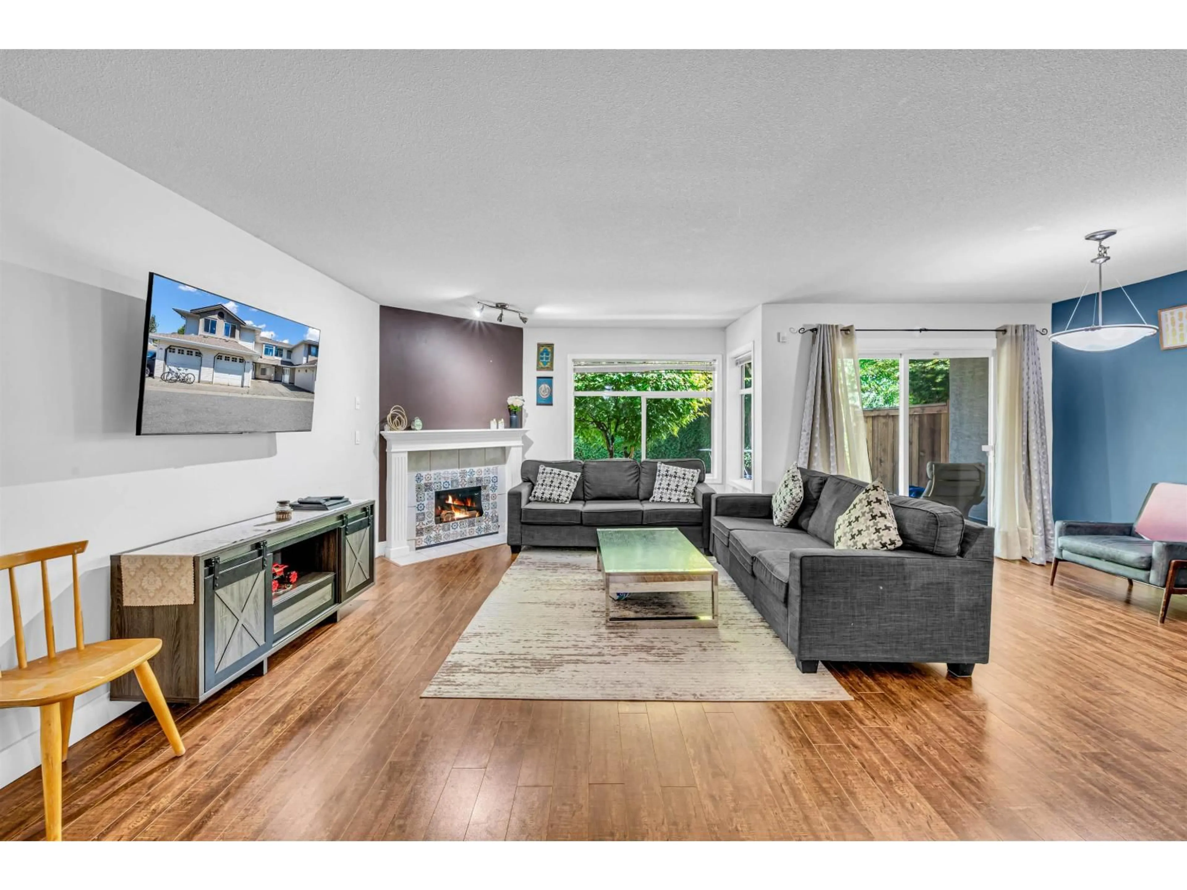 Living room with furniture, wood/laminate floor for 202 - 8260 162A STREET, Surrey British Columbia V4N0P6