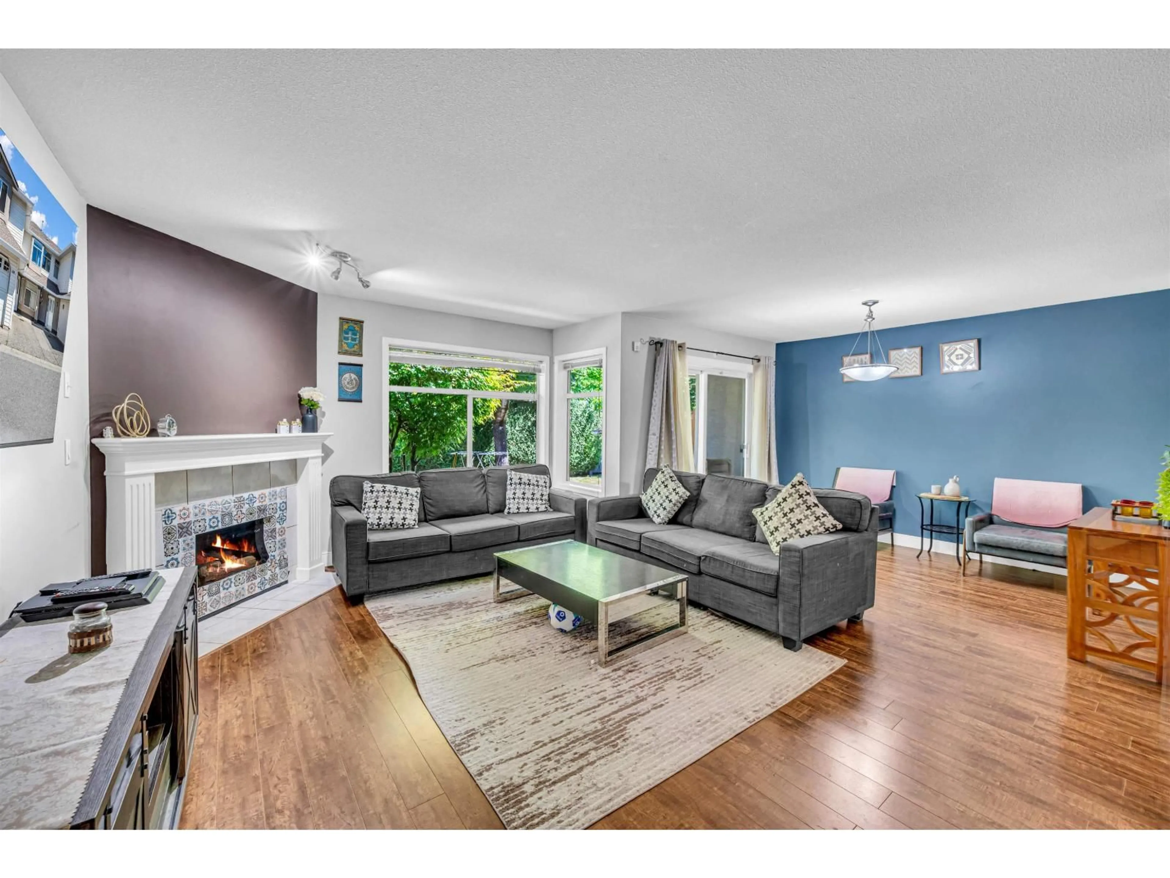 Living room with furniture, wood/laminate floor for 202 - 8260 162A STREET, Surrey British Columbia V4N0P6