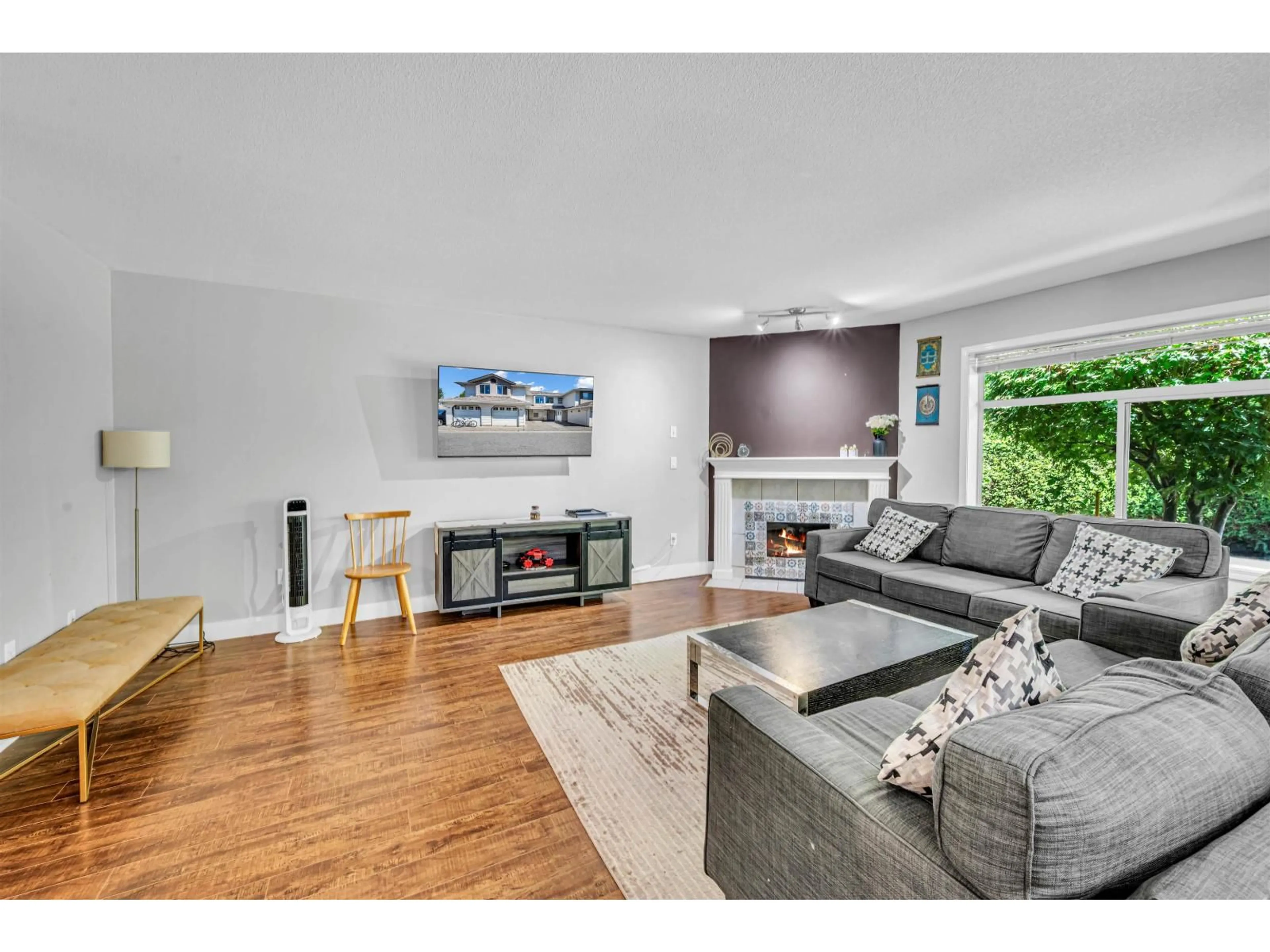 Living room with furniture, wood/laminate floor for 202 - 8260 162A STREET, Surrey British Columbia V4N0P6
