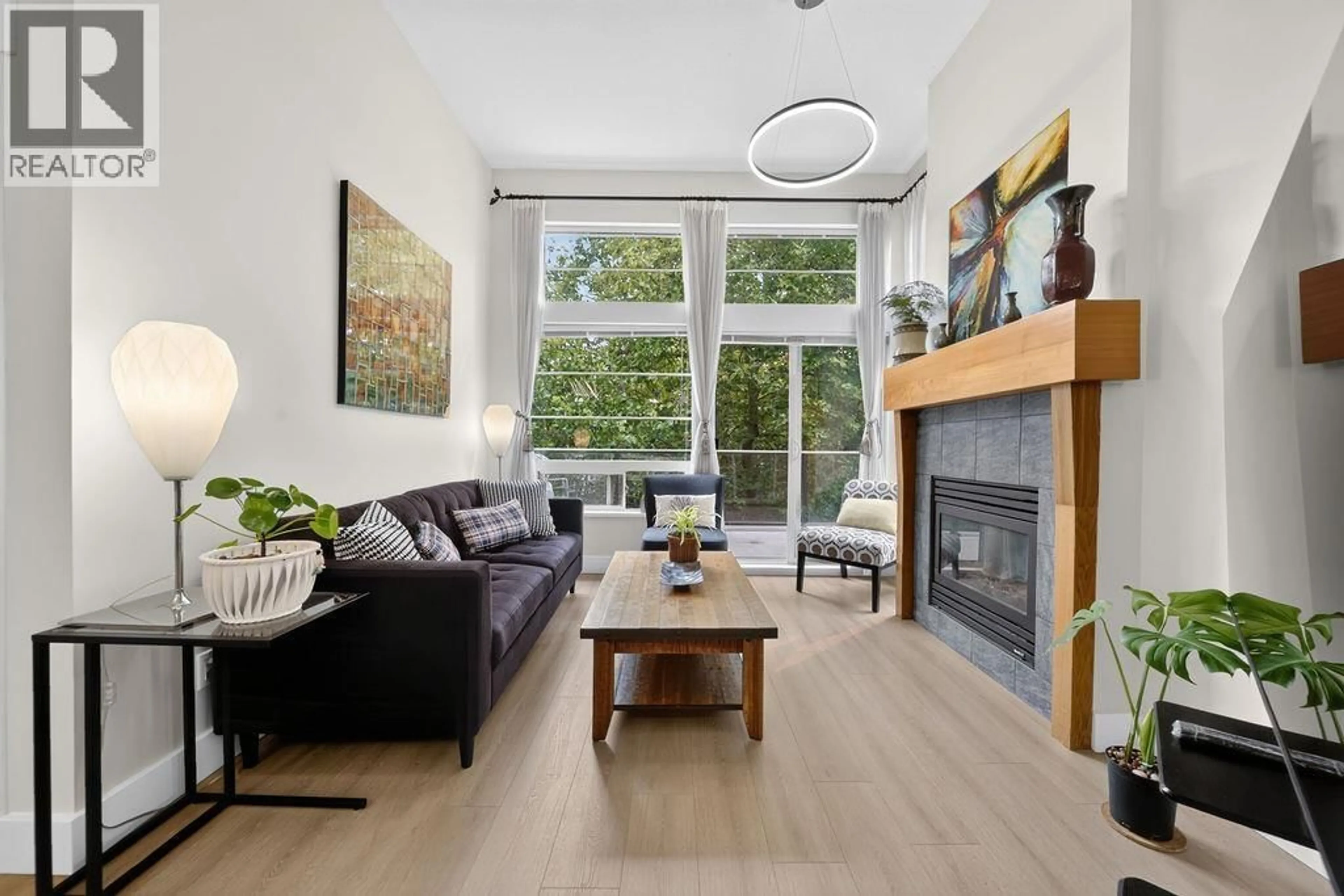 Living room with furniture, wood/laminate floor for 407 - 6328 LARKIN DRIVE, Vancouver British Columbia V6T2K2