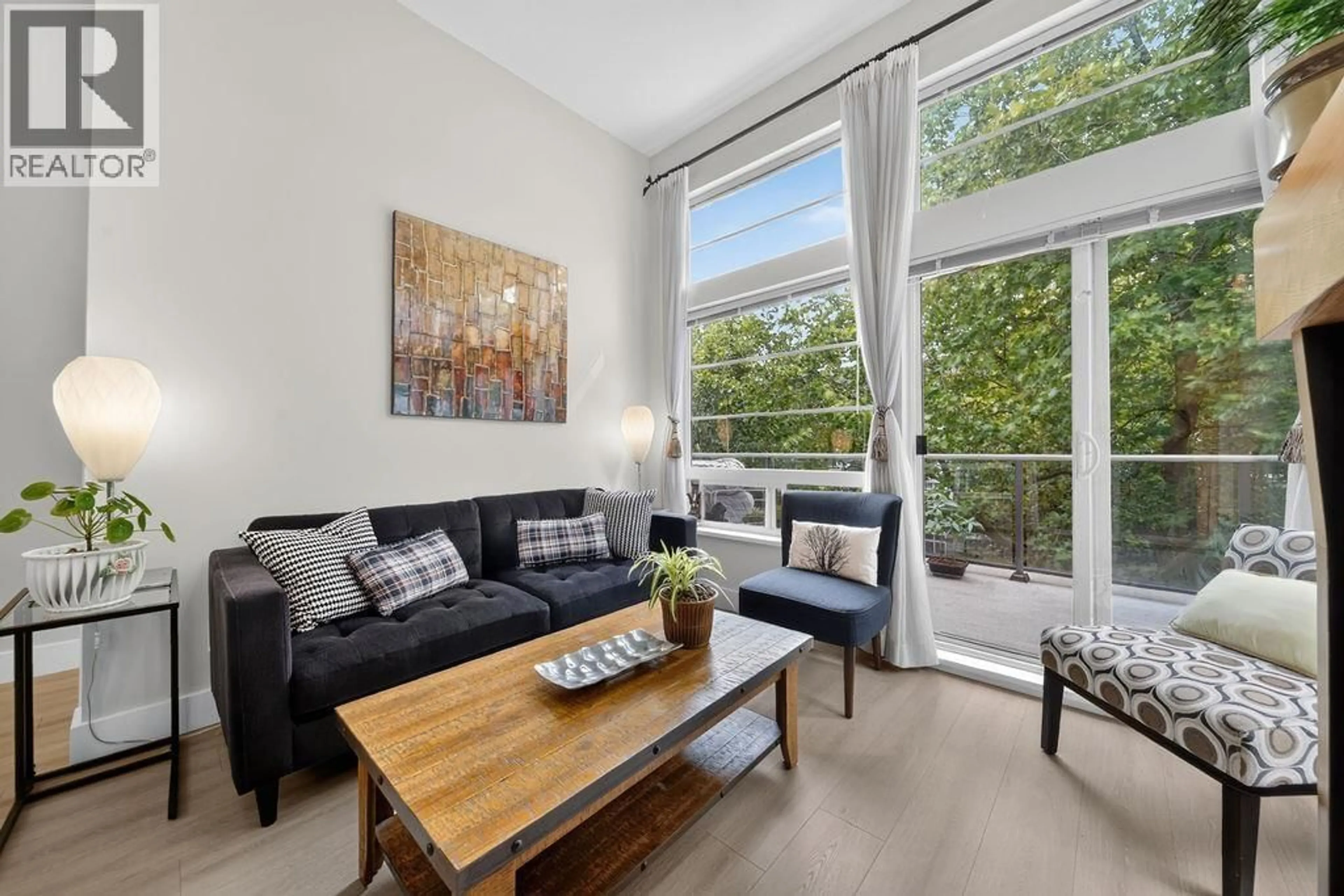 Living room with furniture, wood/laminate floor for 407 - 6328 LARKIN DRIVE, Vancouver British Columbia V6T2K2