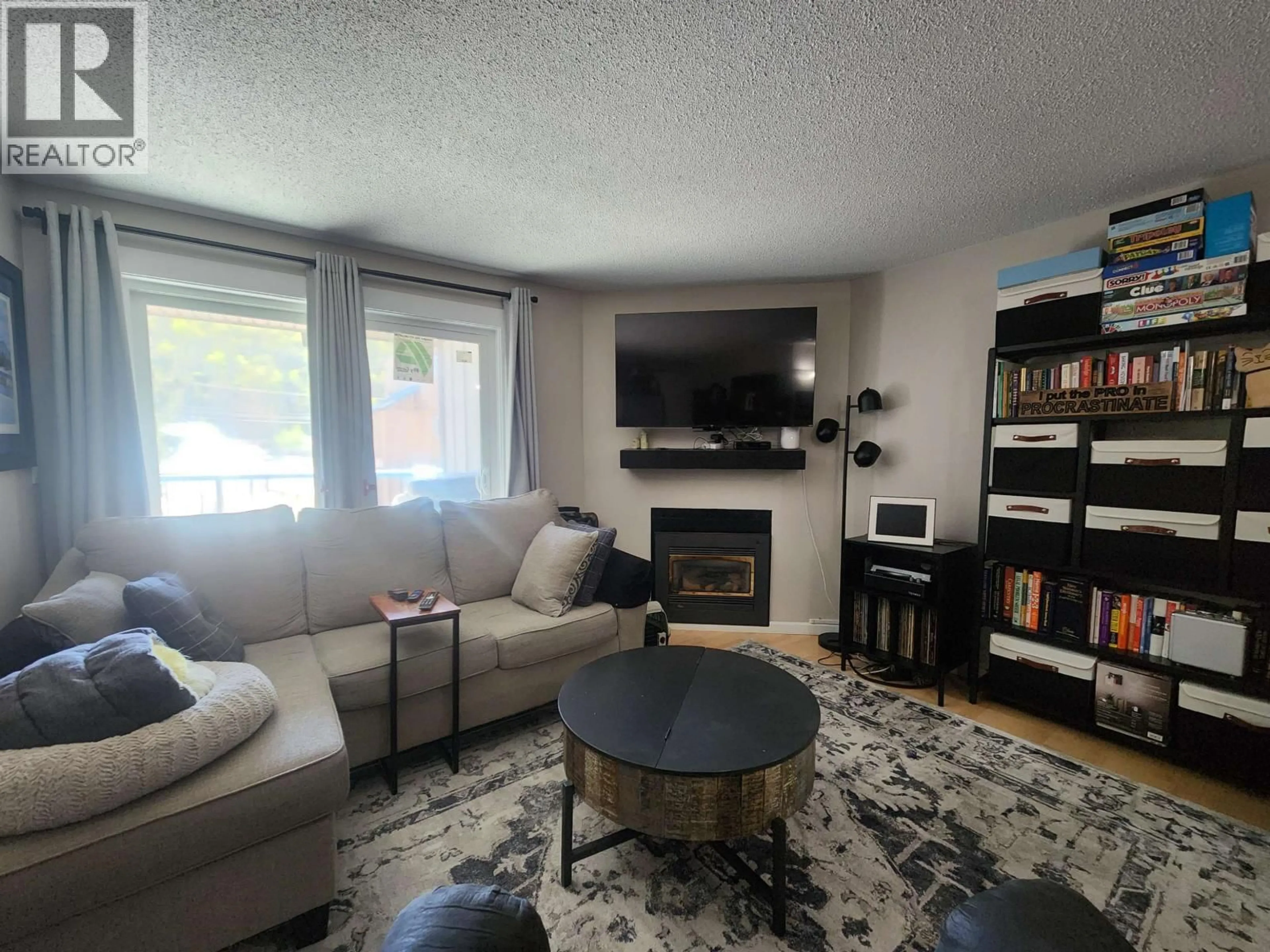 Living room with furniture, wood/laminate floor for 202 - 3033 OSPIKA BOULEVARD, Prince George British Columbia V2N4L5