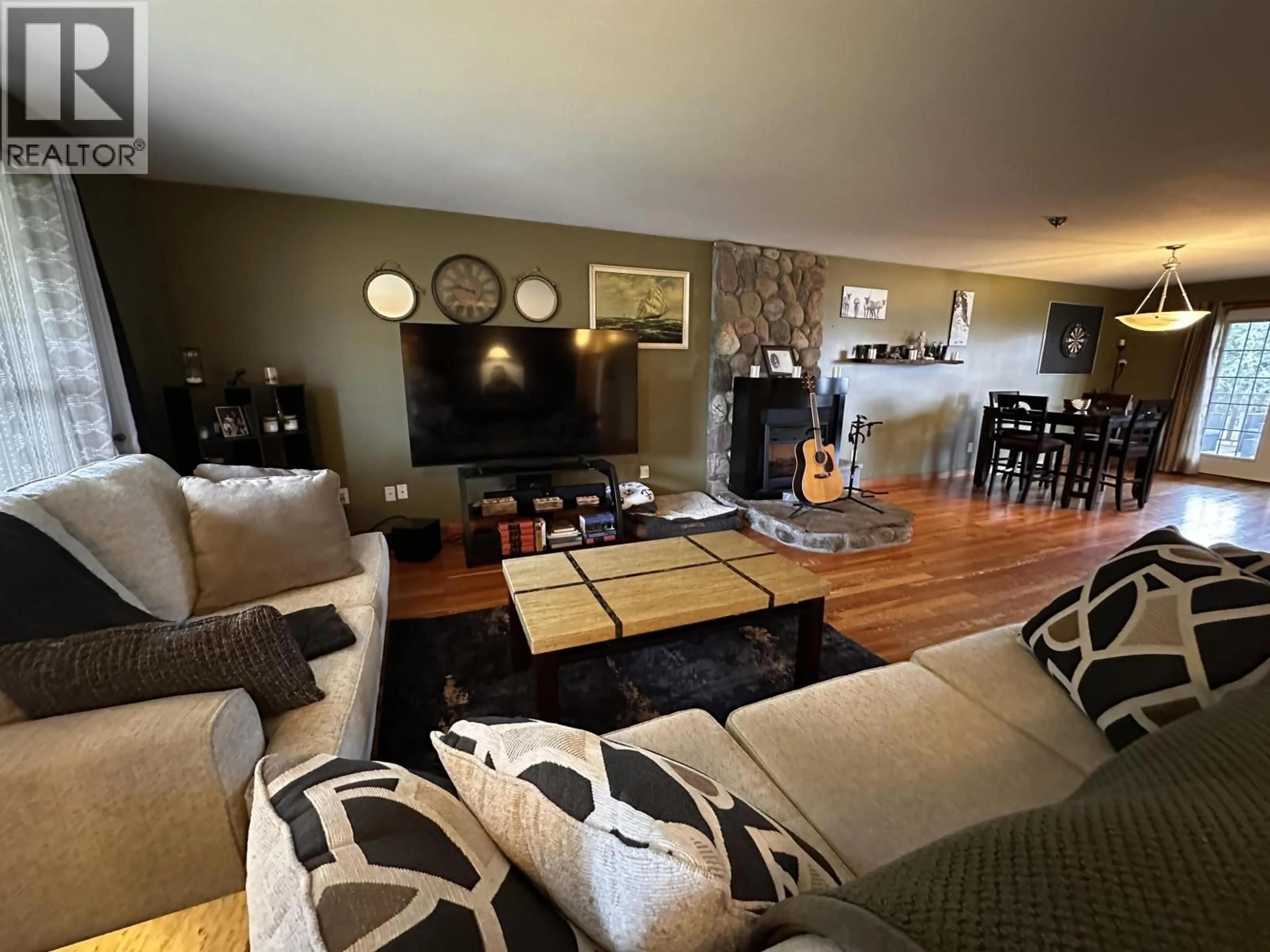 Living room with furniture, wood/laminate floor for 4410 52 AVENUE, Fort Nelson British Columbia V0C1R0