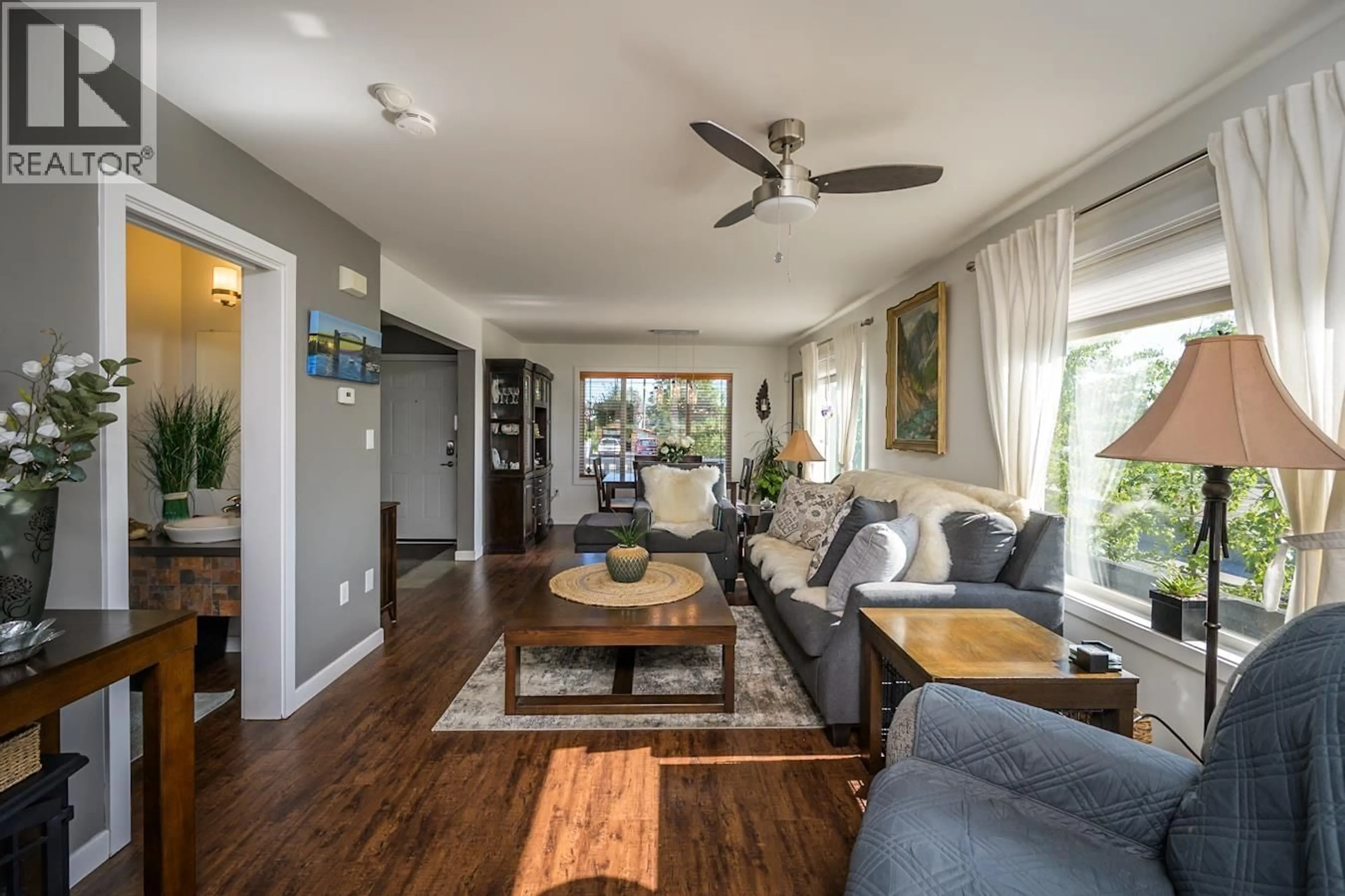 Living room with furniture, wood/laminate floor for 1807 12TH AVENUE, Prince George British Columbia V2M1P8