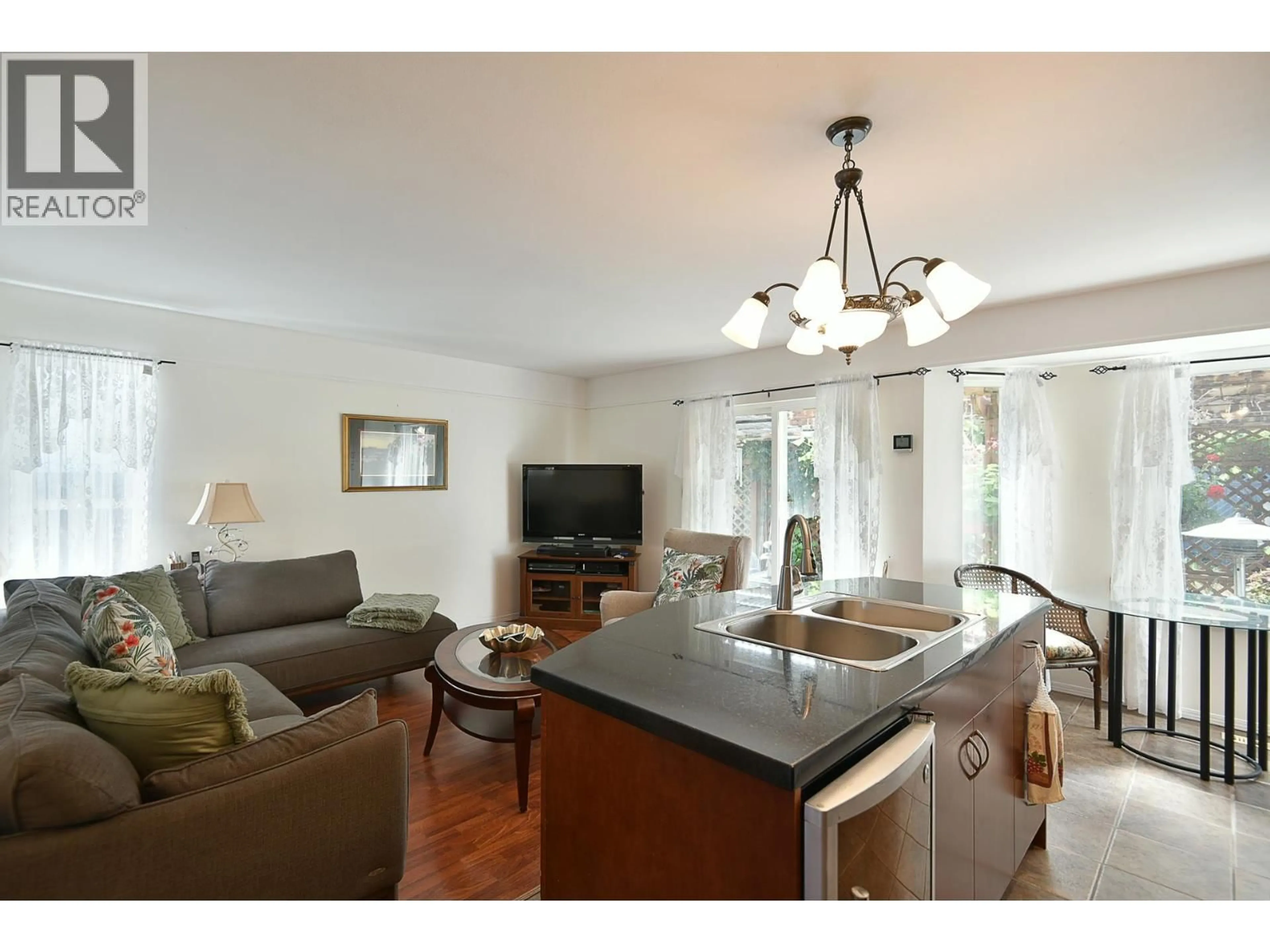 Open concept kitchen, wood/laminate floor for 5875 TURNSTONE CRESCENT, Sechelt British Columbia V7Z0L9