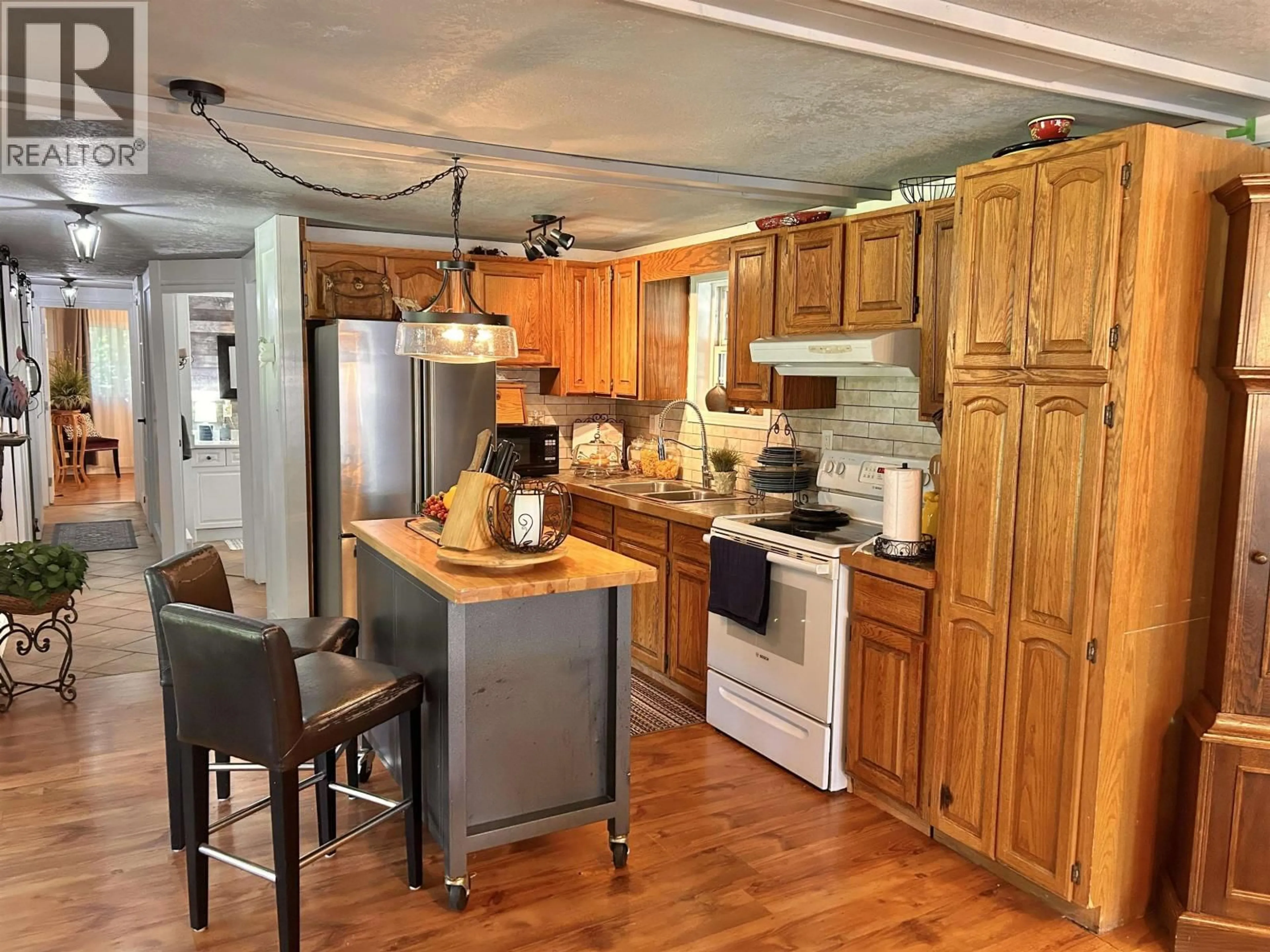 Open concept kitchen, wood/laminate floor for 1122 ELLISON ROAD, Quesnel British Columbia V2J5L6