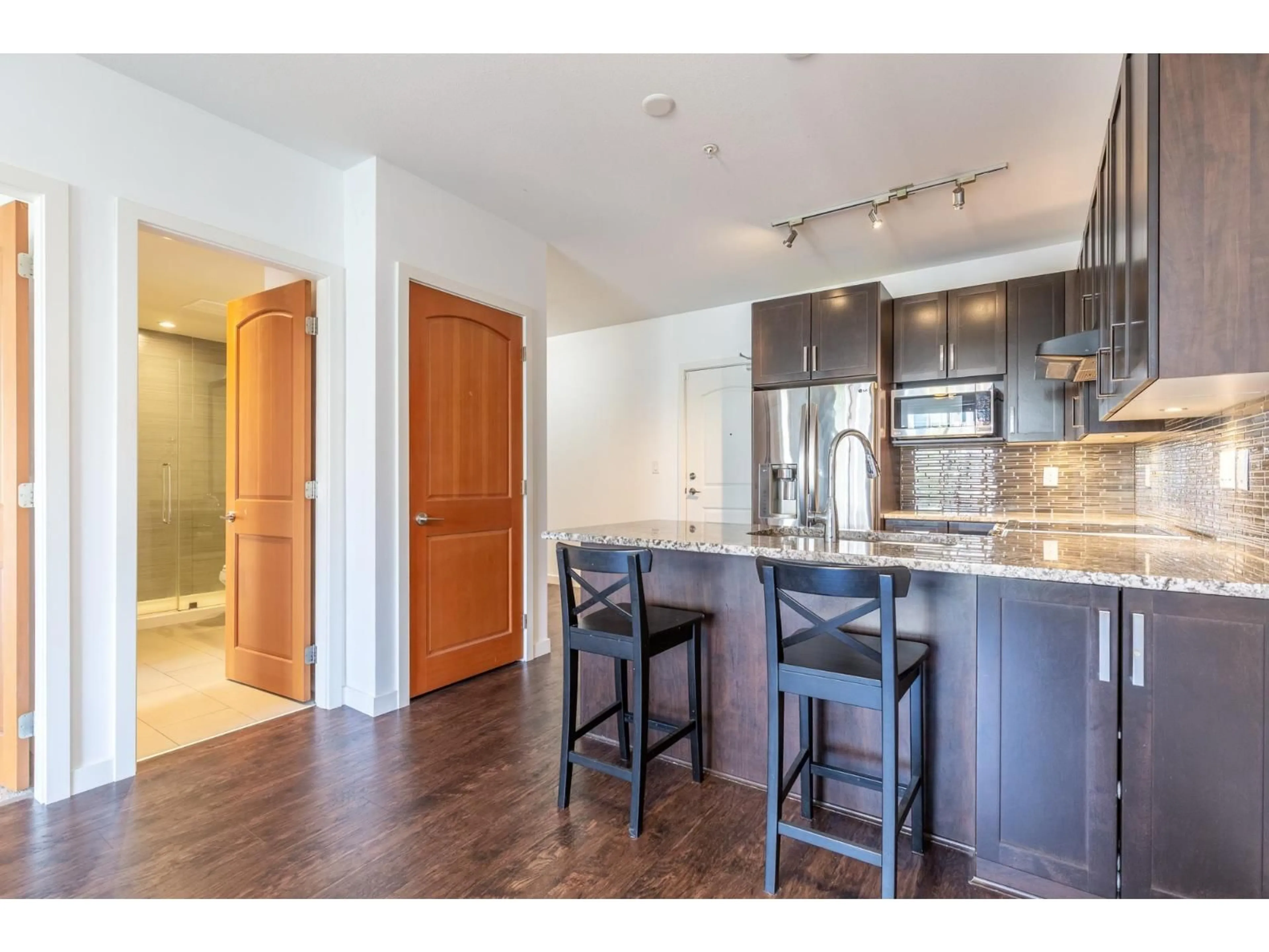Open concept kitchen, wood/laminate floor for 307 - 6480 194 STREET, Surrey British Columbia V4N6J9