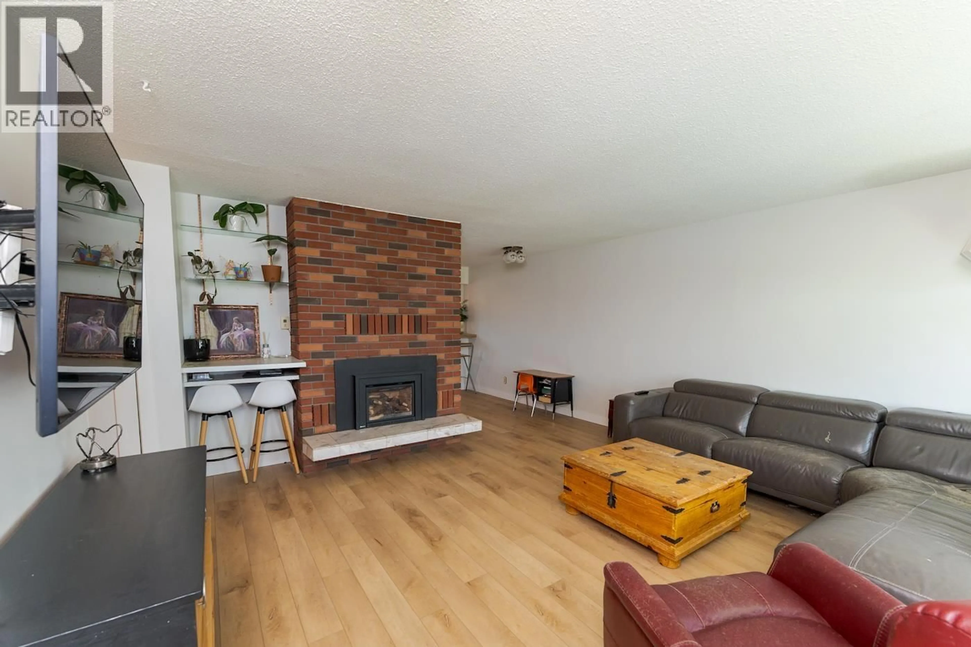 Living room with furniture, wood/laminate floor for 8805 CHILCOTIN ROAD, Prince George British Columbia V2N5V9