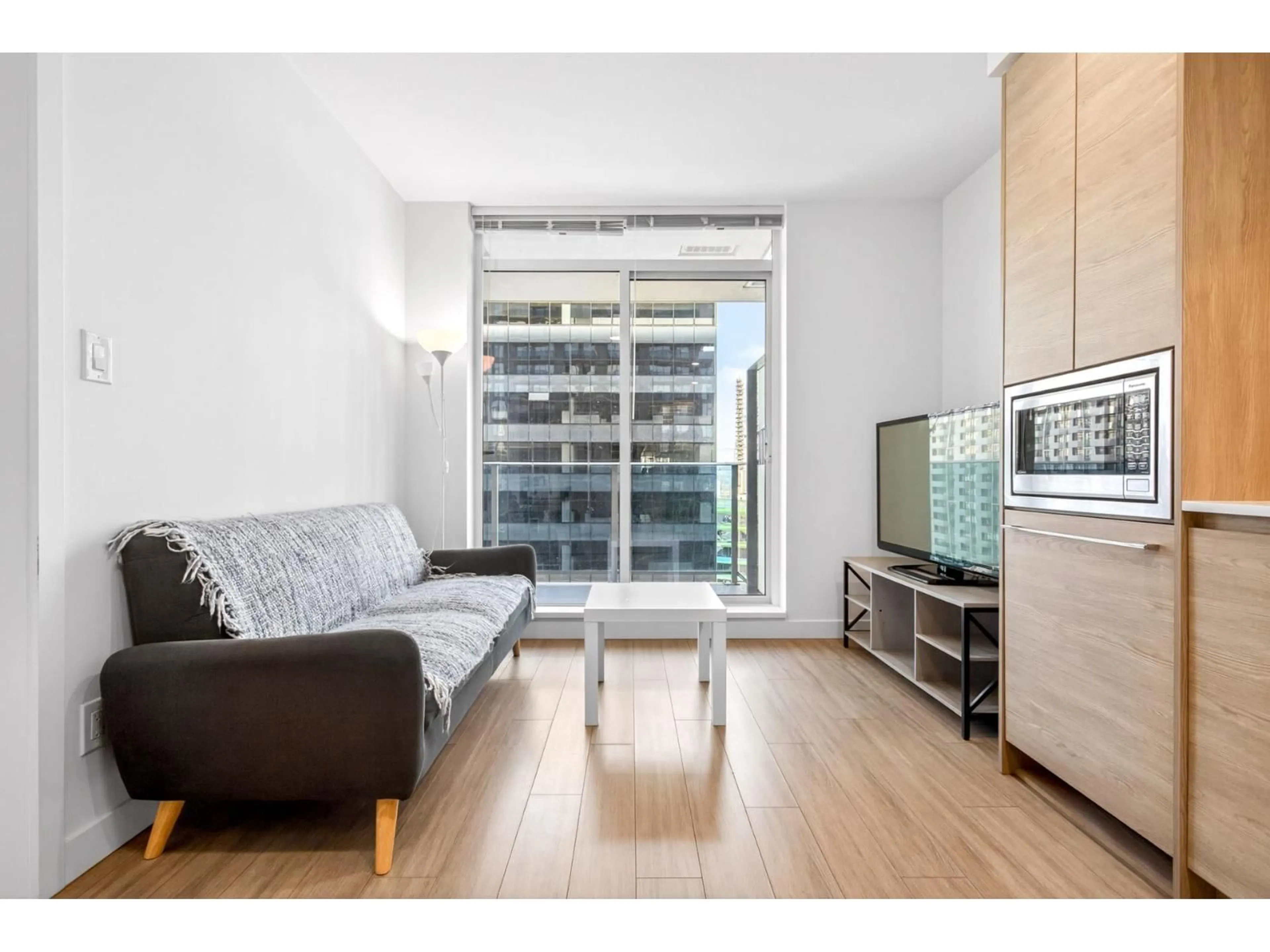 Living room with furniture, wood/laminate floor for 1607 - 13615 FRASER HIGHWAY, Surrey British Columbia V3T0P7