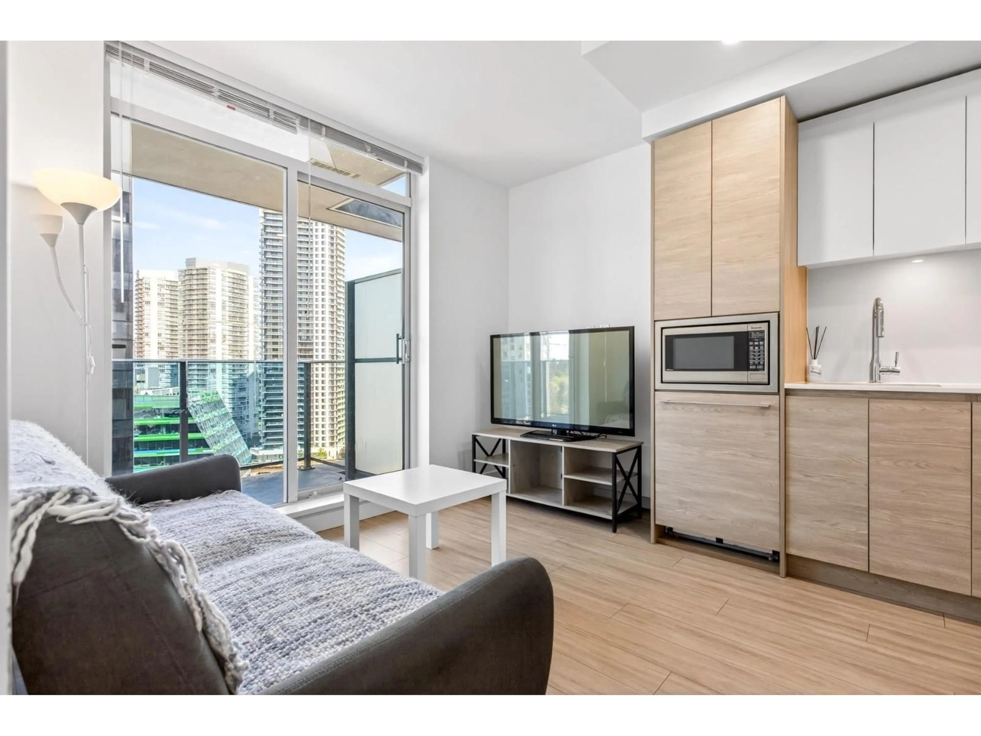 Living room with furniture, wood/laminate floor for 1607 - 13615 FRASER HIGHWAY, Surrey British Columbia V3T0P7
