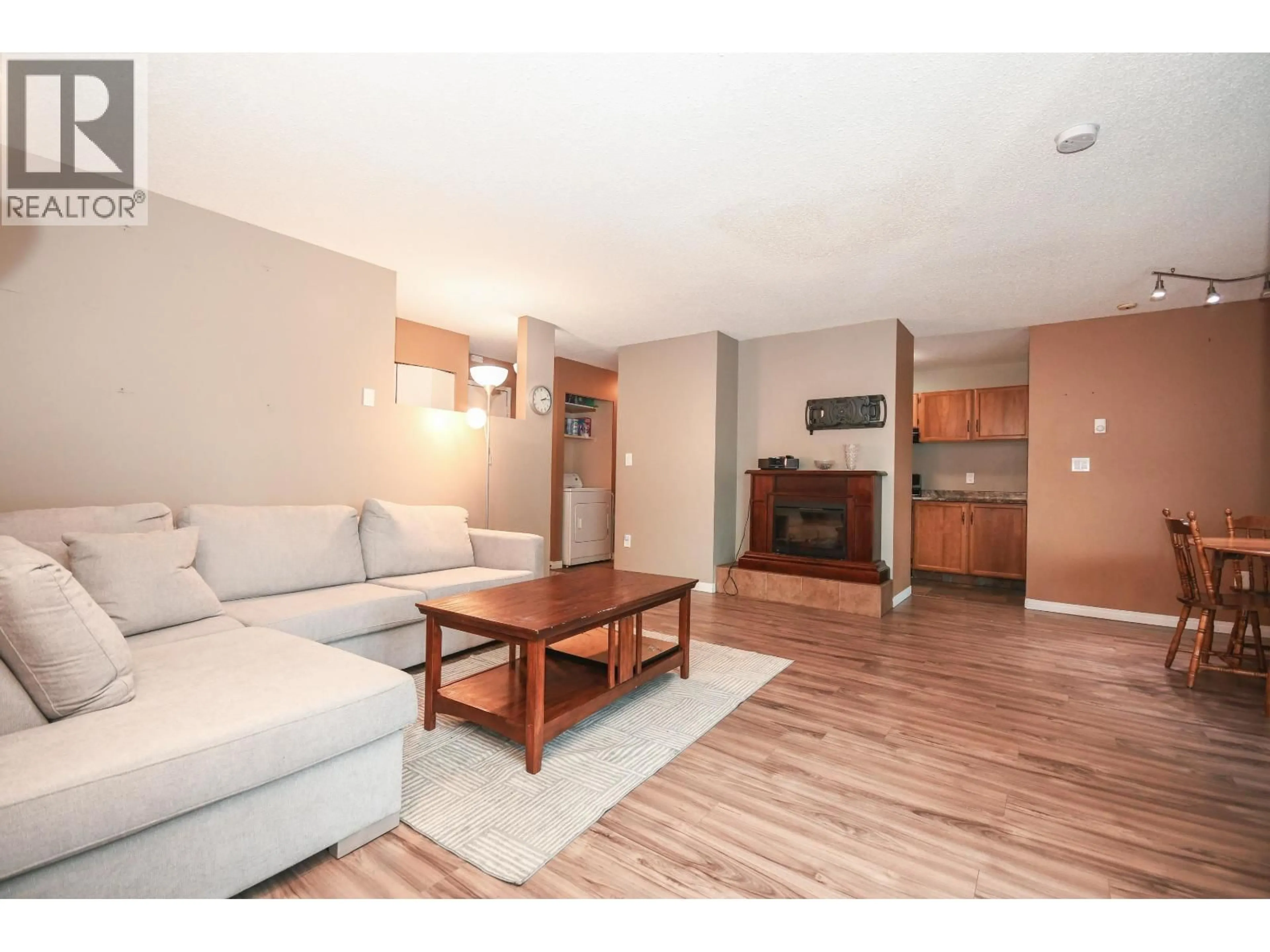 Living room with furniture, wood/laminate floor for 214 - 3033 OSPIKA BOULEVARD, Prince George British Columbia V2N4L5
