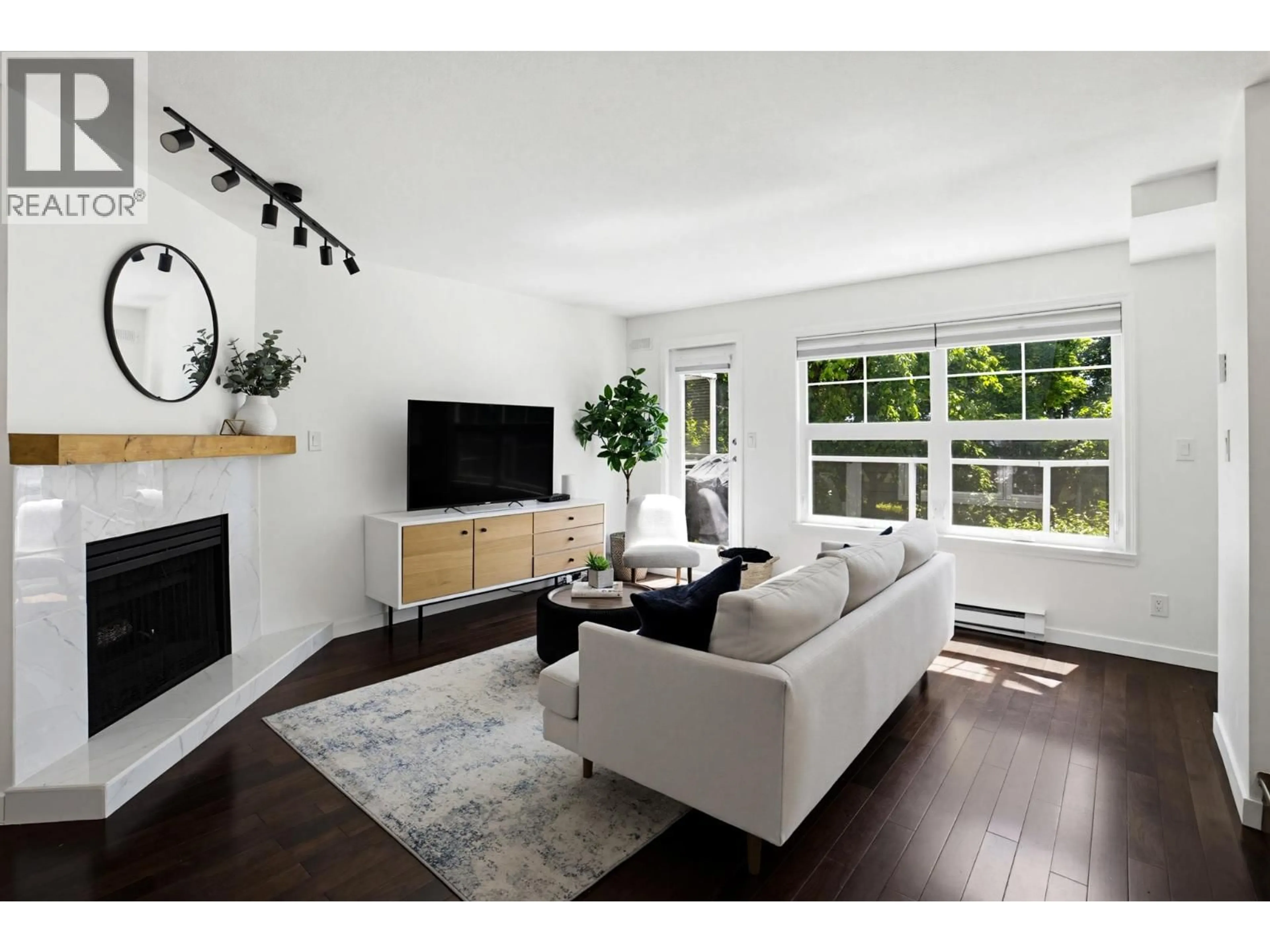Living room with furniture, wood/laminate floor for 213 - 3787 PENDER STREET, Burnaby British Columbia V5C2L2