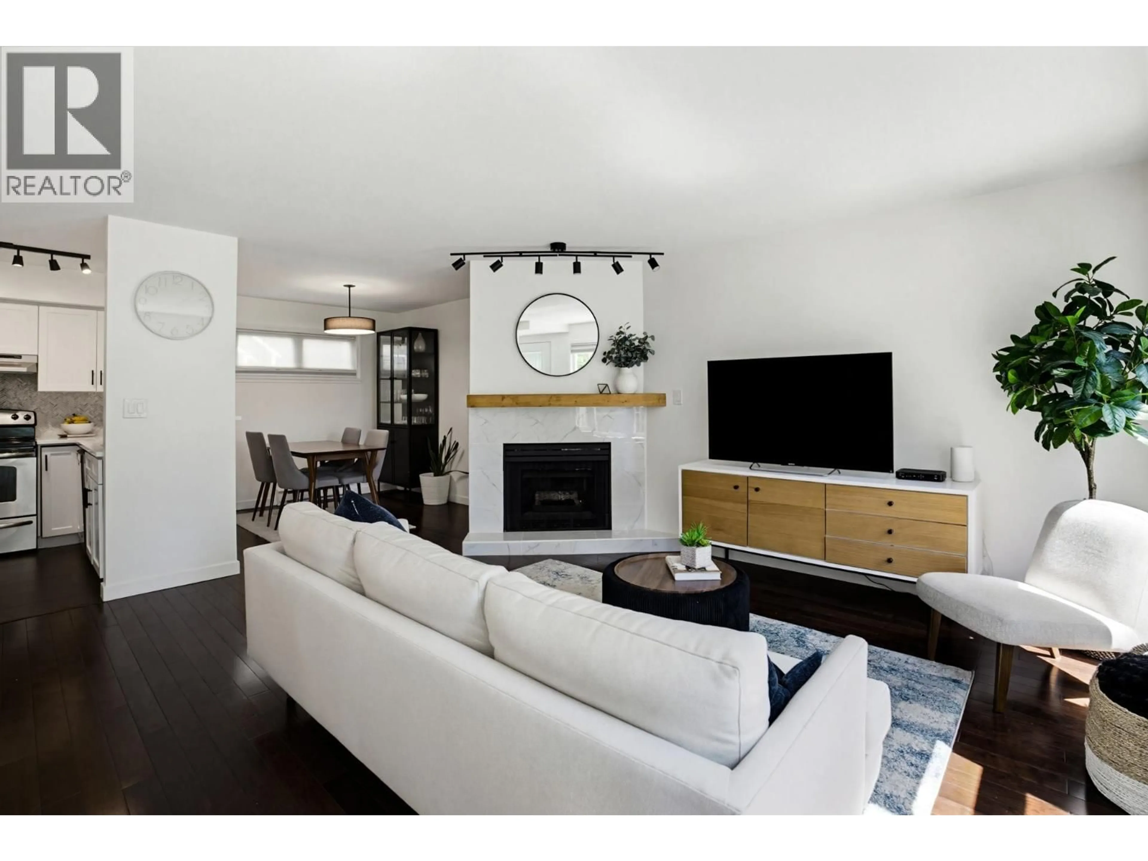 Living room with furniture, wood/laminate floor for 213 - 3787 PENDER STREET, Burnaby British Columbia V5C2L2