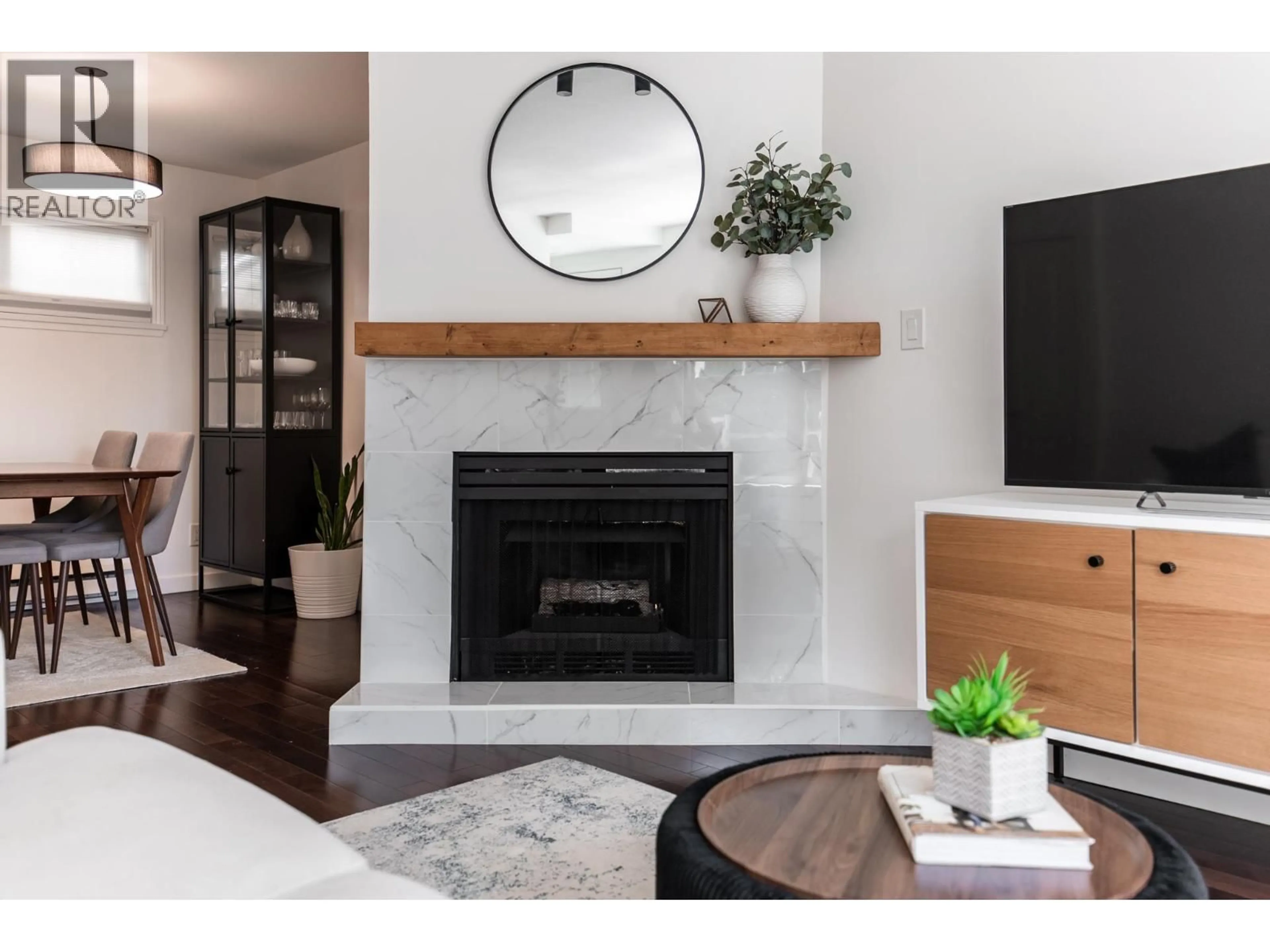 Living room with furniture, wood/laminate floor for 213 - 3787 PENDER STREET, Burnaby British Columbia V5C2L2