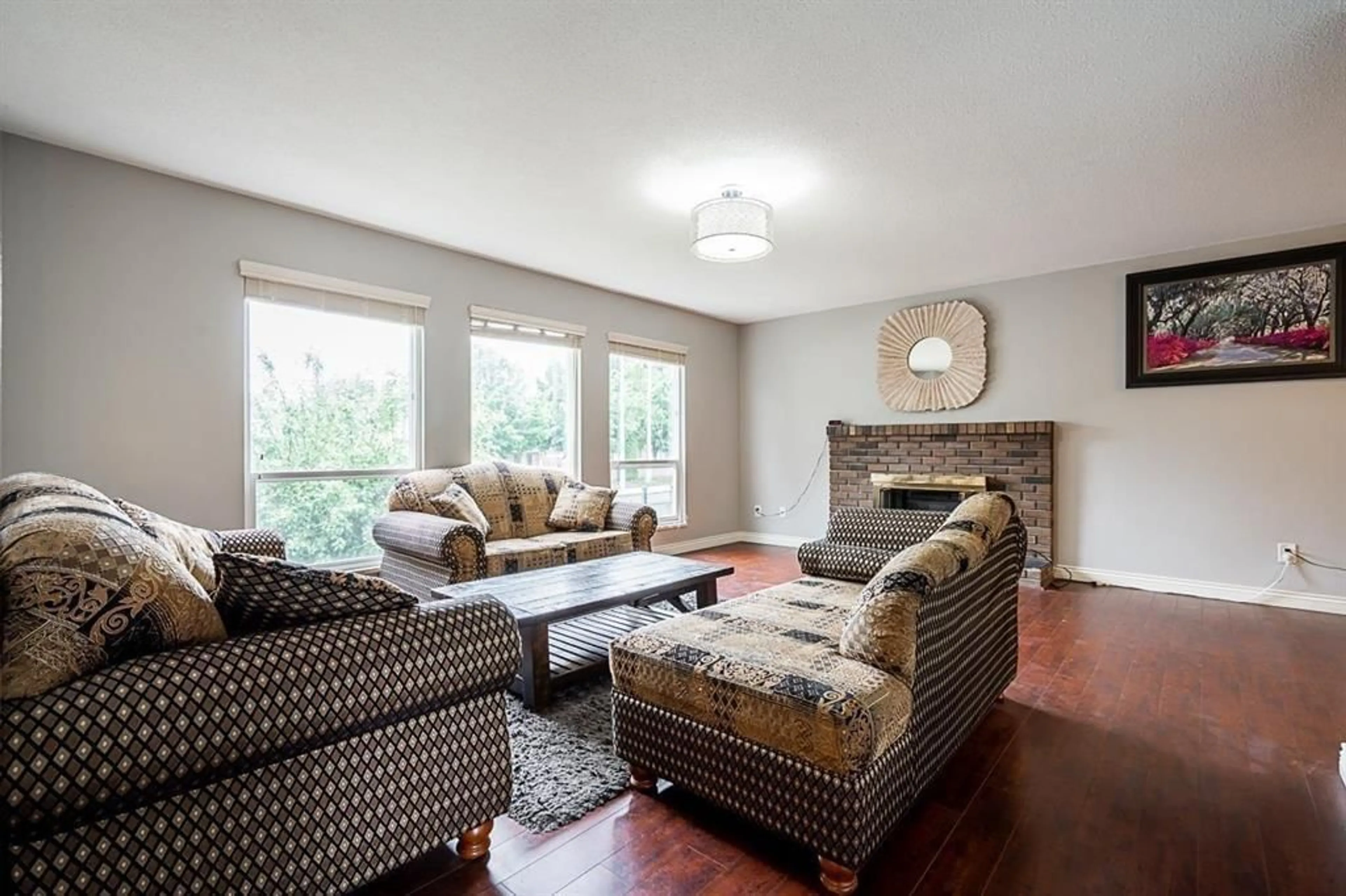 Living room with furniture, wood/laminate floor for 12845 64 AVENUE, Surrey British Columbia V3W1X4