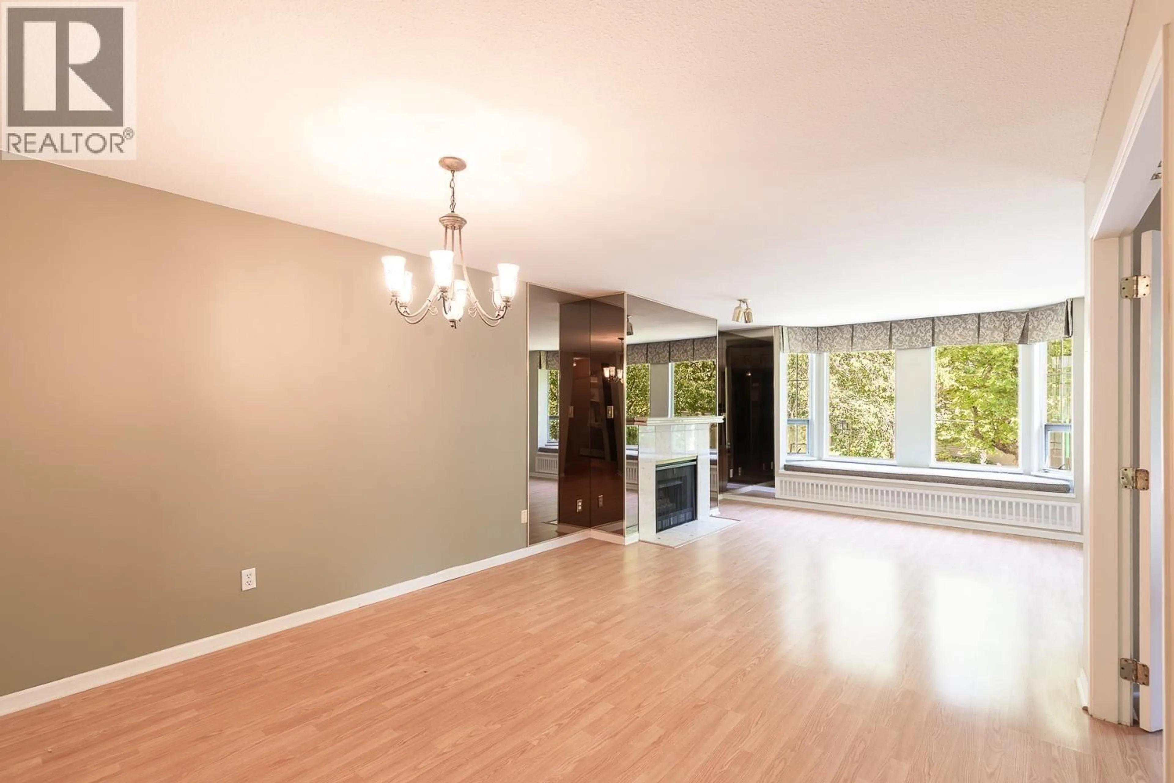 Living room with furniture, wood/laminate floor for 208 - 1695 AUGUSTA AVENUE, Burnaby British Columbia V5A4S8