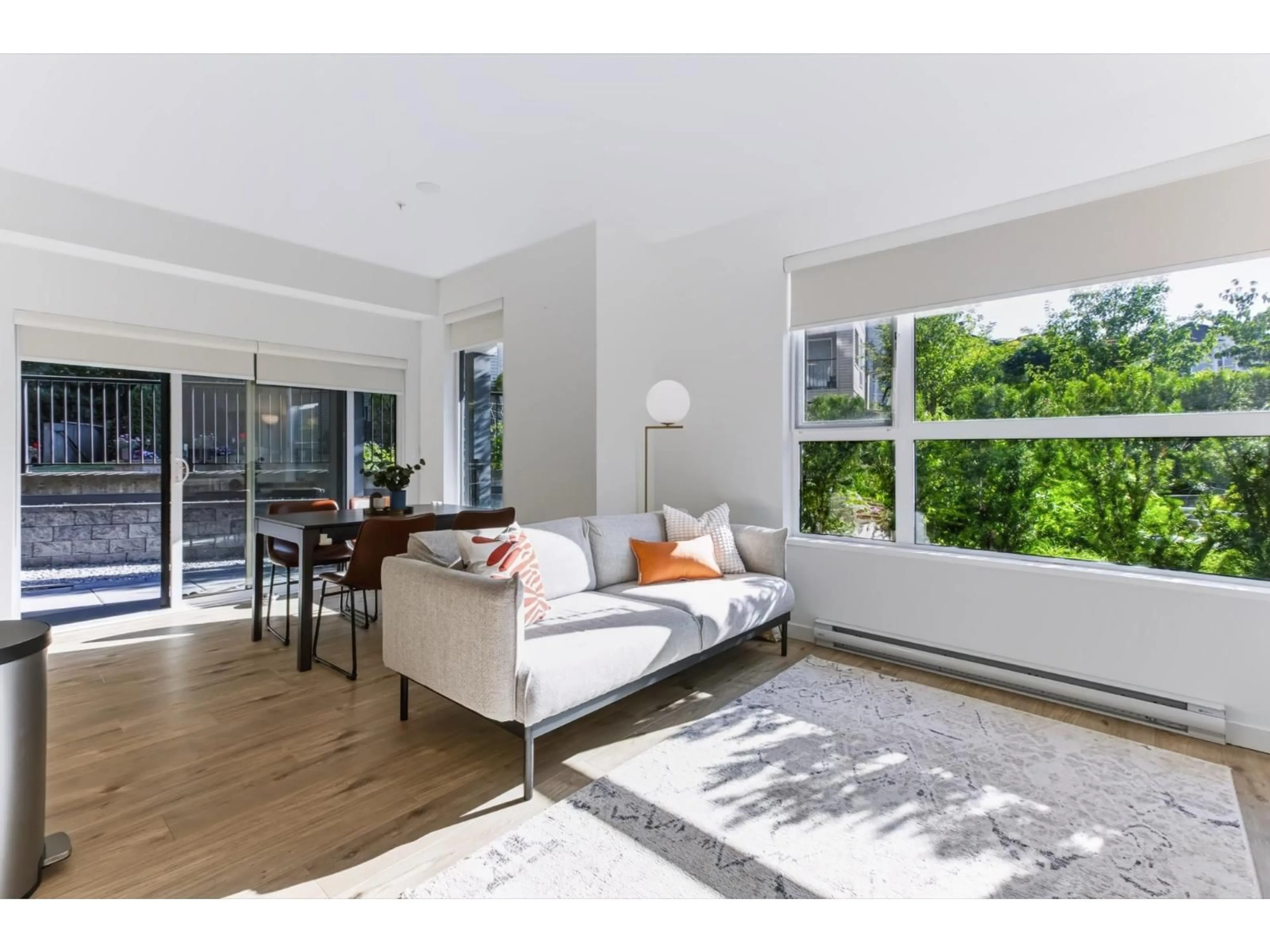 Living room with furniture, wood/laminate floor for 102 - 3182 GLADWIN ROAD, Abbotsford British Columbia V2T0K8