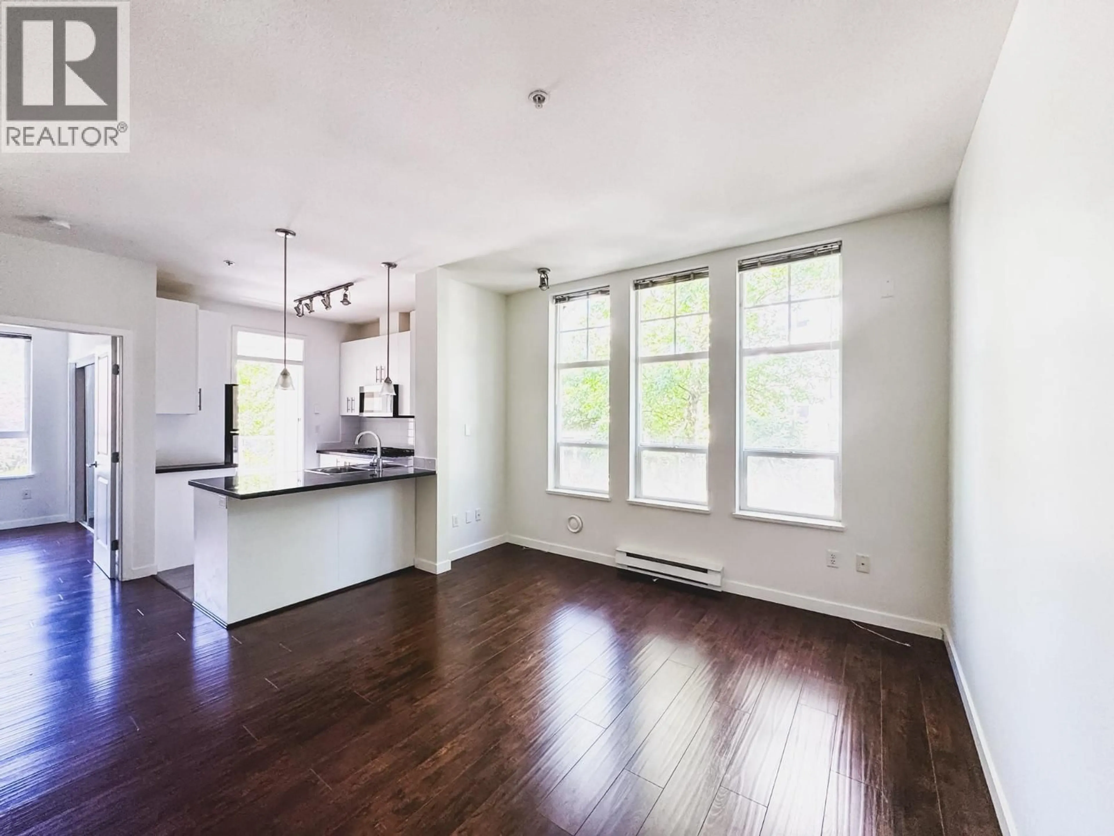 Open concept kitchen, wood/laminate floor for 210 - 3651 FOSTER AVENUE, Vancouver British Columbia V5R0A2