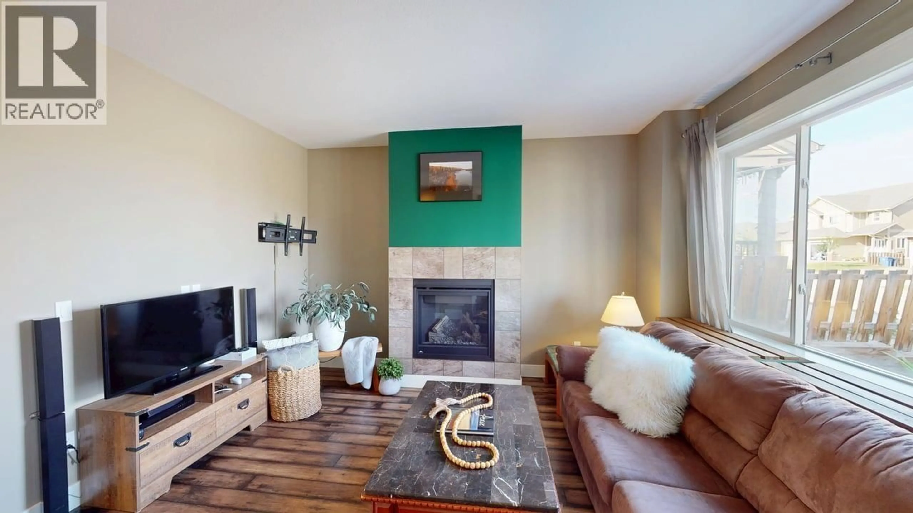 Living room with furniture, wood/laminate floor for 8630 82 STREET, Fort St. John British Columbia V1J0B4