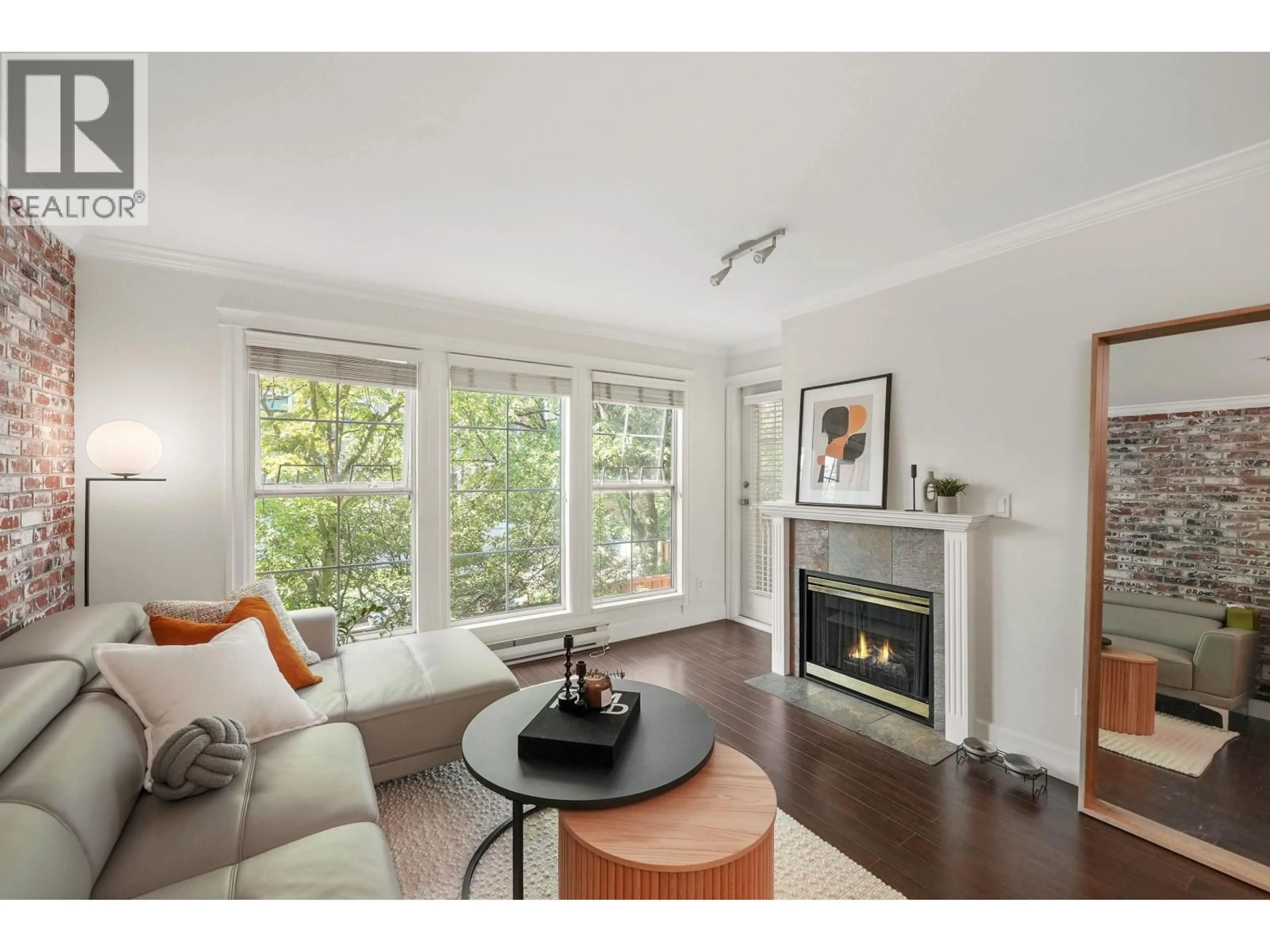 Living room with furniture, wood/laminate floor for 302 - 888 GAUTHIER AVENUE, Coquitlam British Columbia V3K6Y1