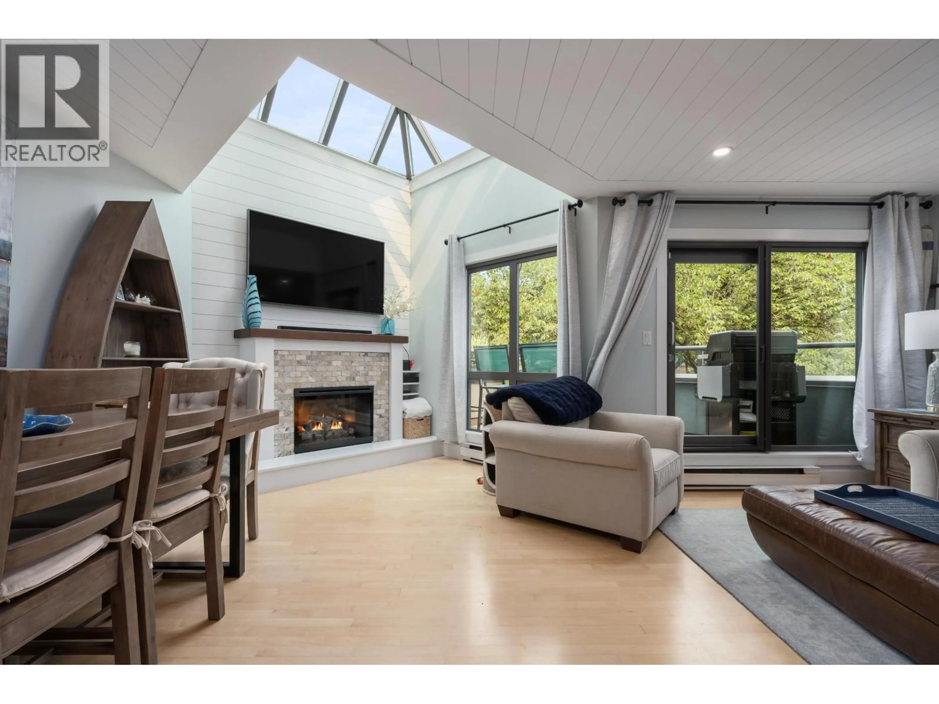Living room with furniture, wood/laminate floor for 104 - 1477 FOUNTAIN WAY, Vancouver British Columbia V6H3W9